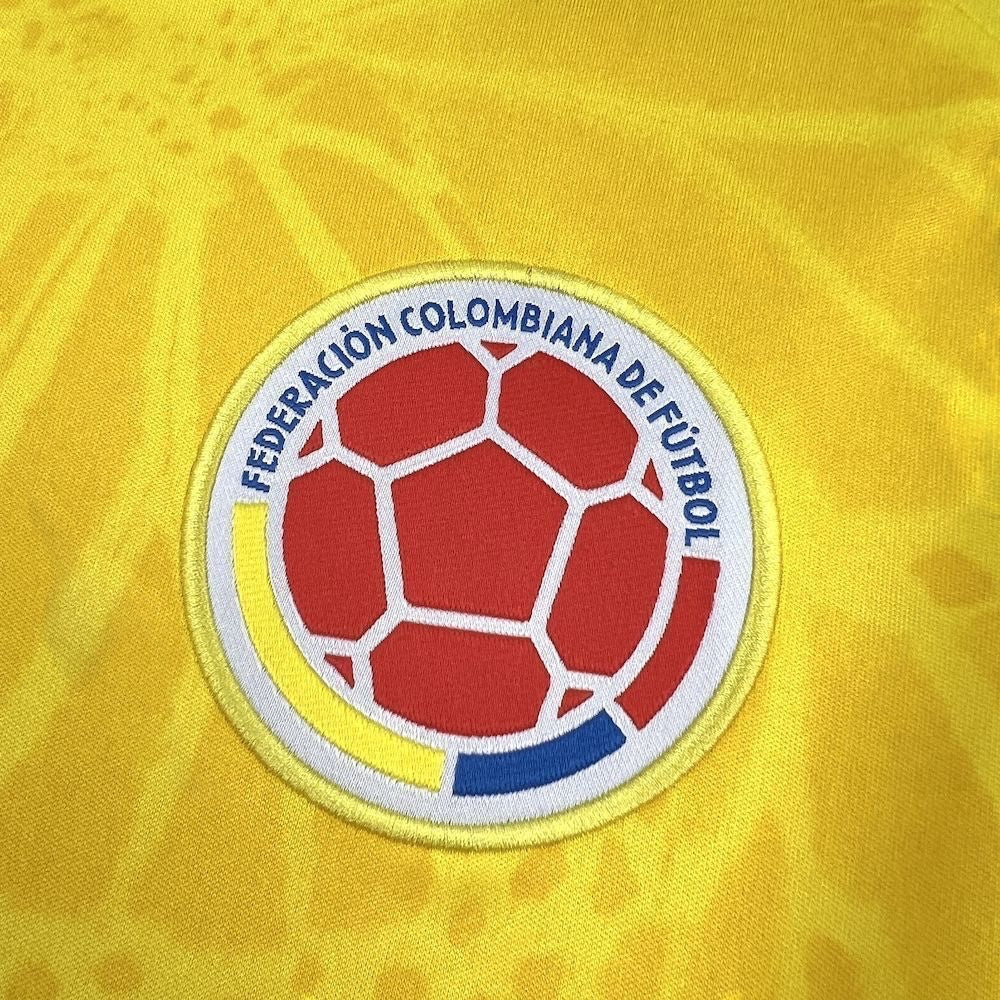 Leazofoot Colombia home football jersey 2026 with embroidered crest featuring a red soccer ball on yellow background.