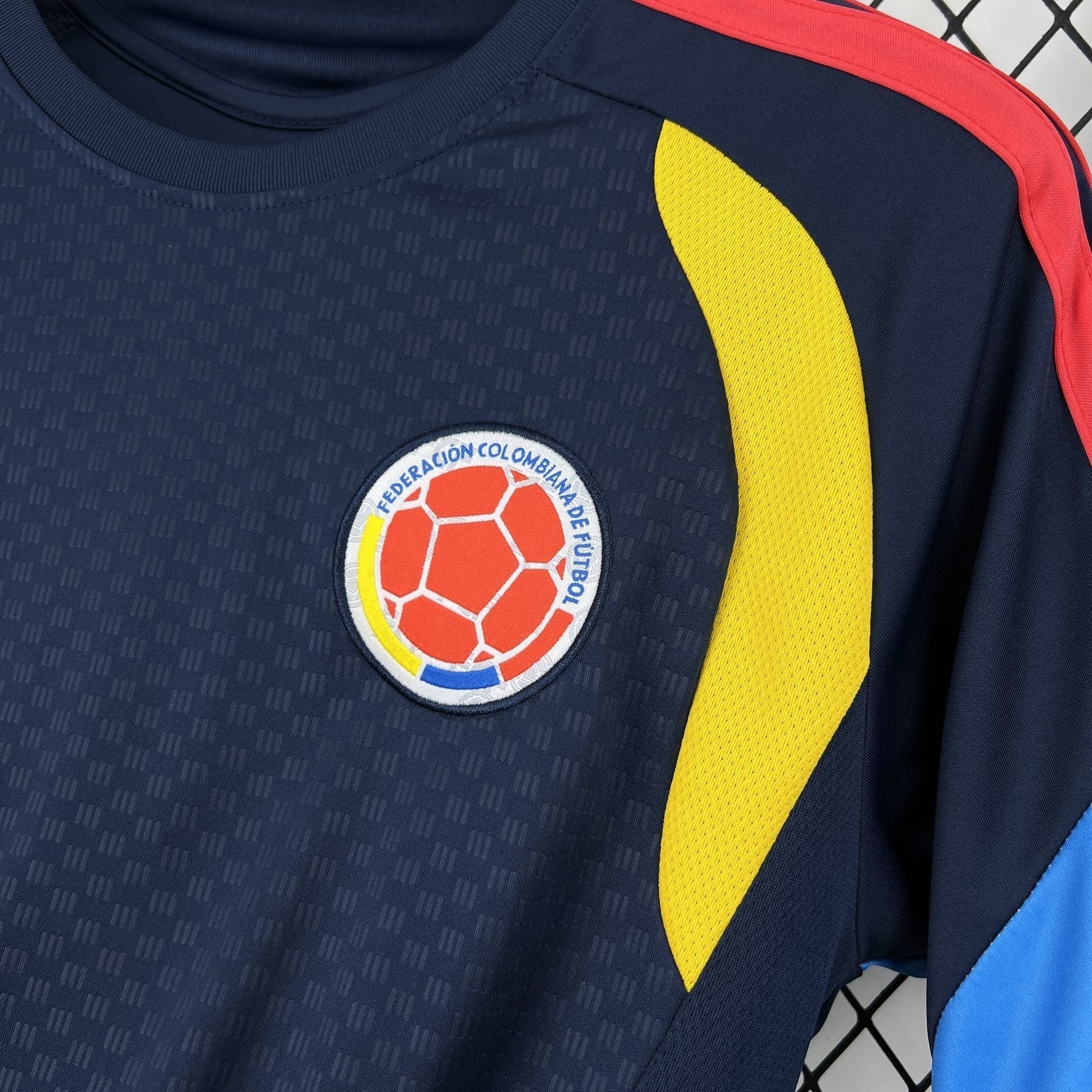 Leazofoot Colombia pre-match football jersey with embroidered crest, navy blue with yellow and red accents.