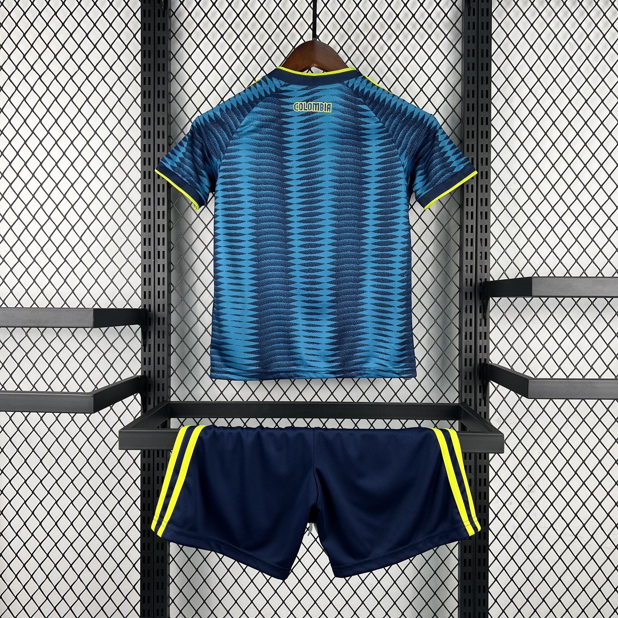 Leazofoot Colombia kids' blue patterned soccer jersey and navy shorts with yellow trim.
