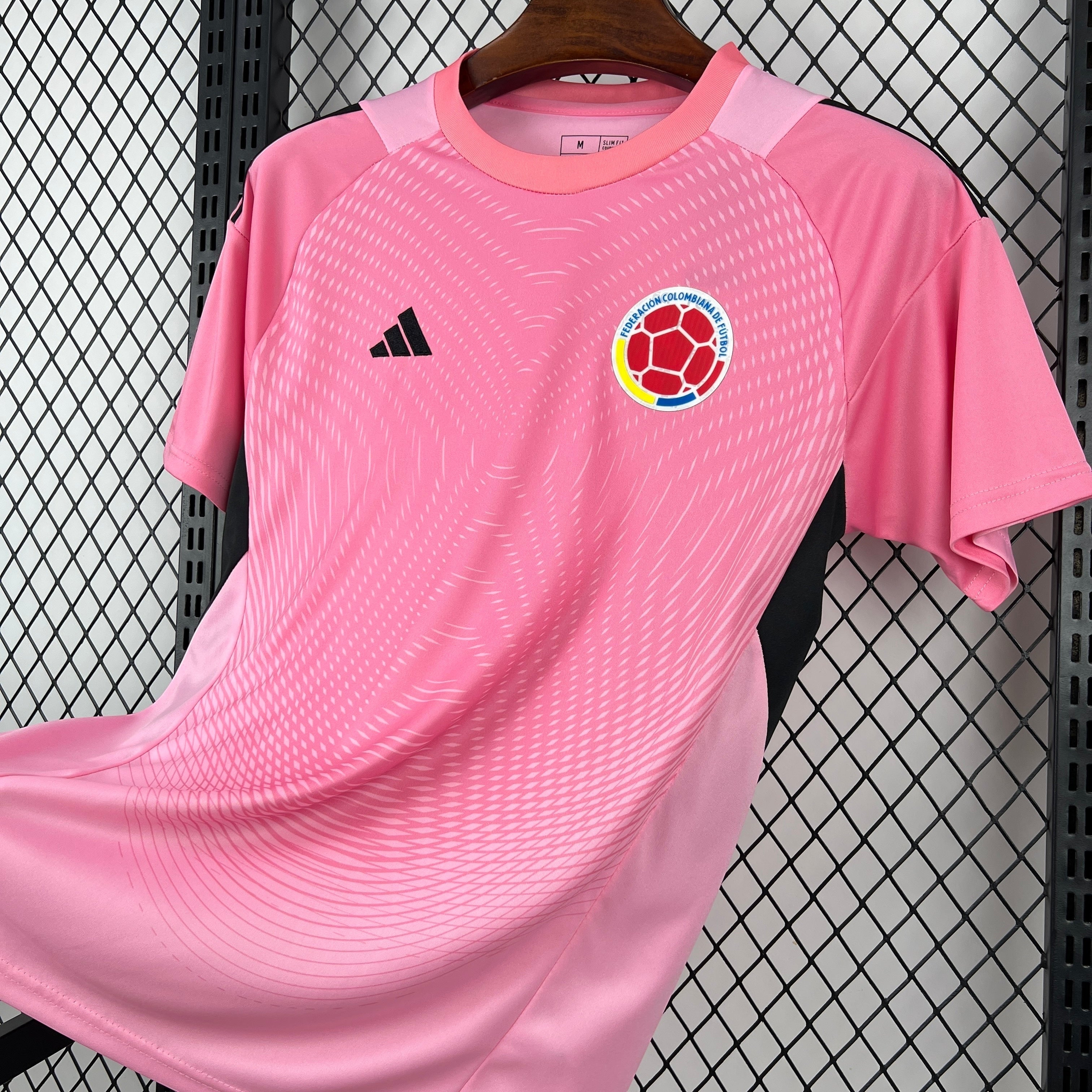 Leazofoot Colombia pre-match football jersey, pink with abstract pattern and team crest.