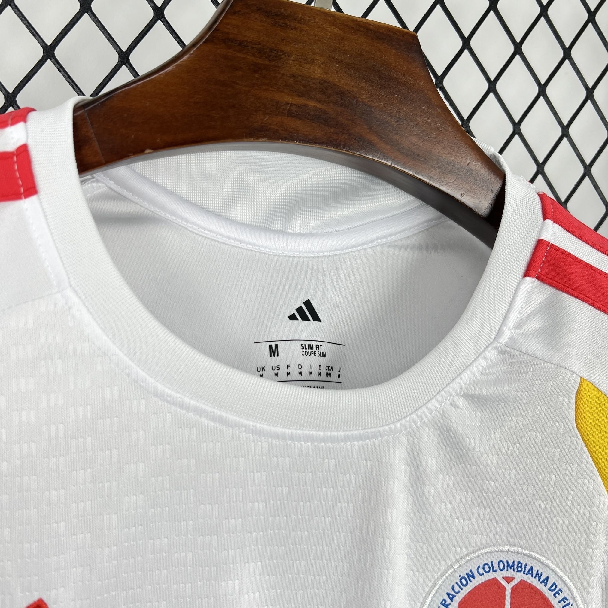 Leazofoot Colombia 2026 pre-match jersey, white with red stripes and yellow accents, slim fit, crew neck.
