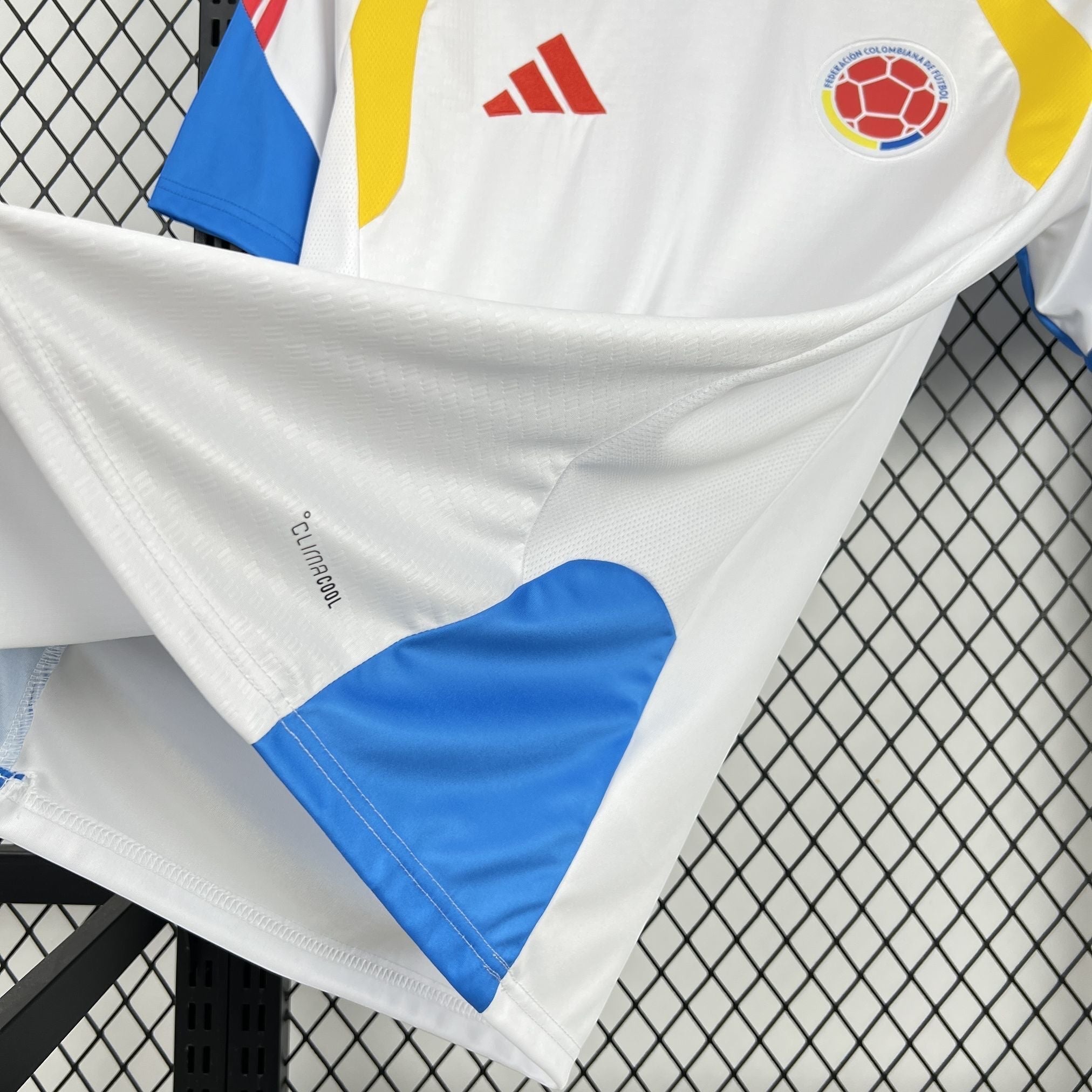 Leazofoot white Colombia soccer jersey with blue and yellow accents, featuring Climacool technology.