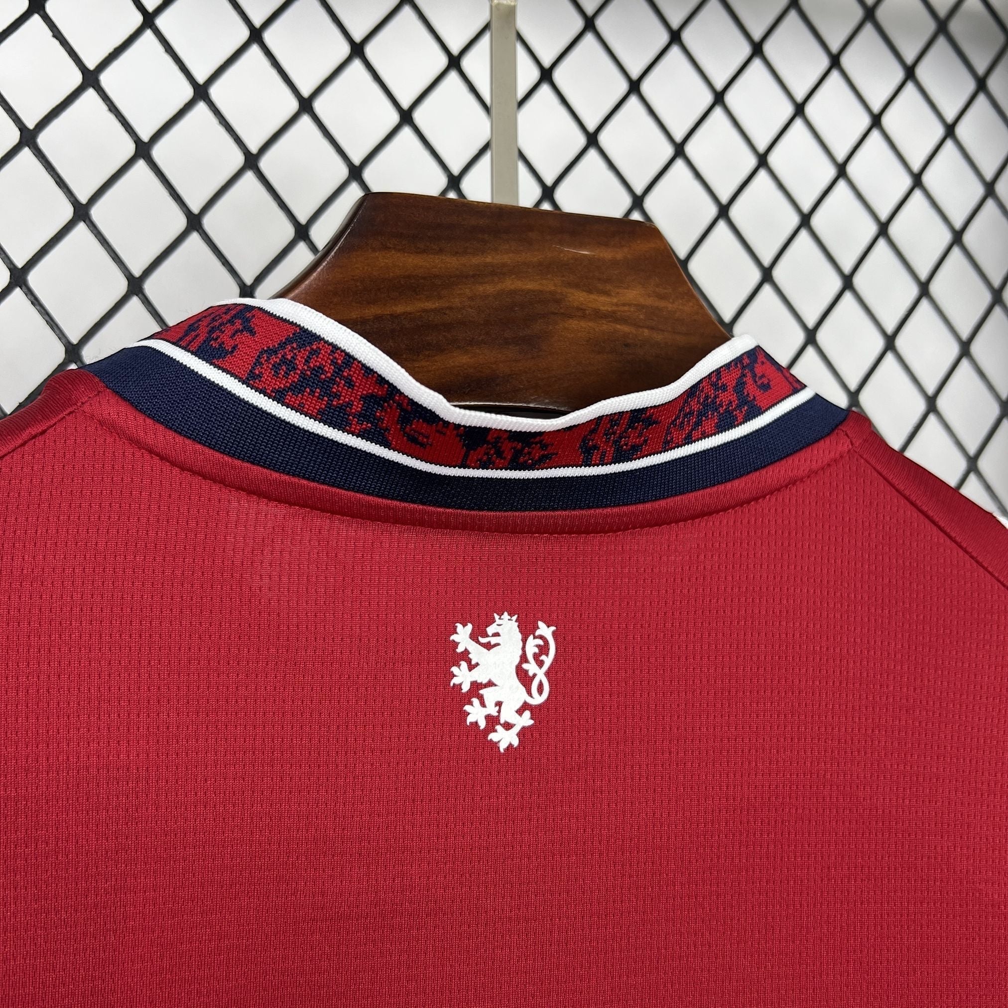 Leazofoot Czech Republic 2026 home jersey. Red shirt with a white lion emblem on the back and a patterned collar.