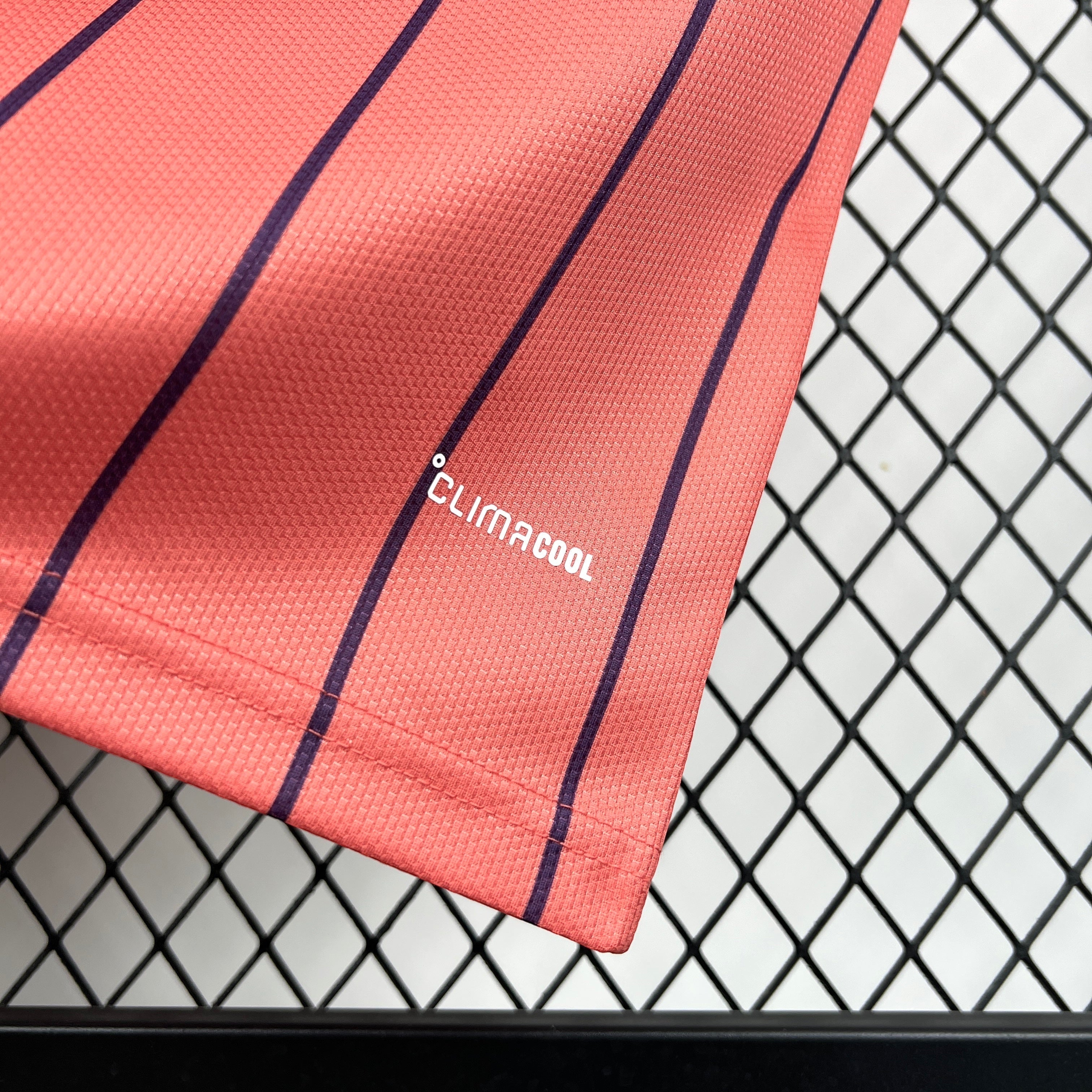 Leazofoot ÉCOSSE 2026 away jersey in coral with navy pinstripes and Climacool technology.