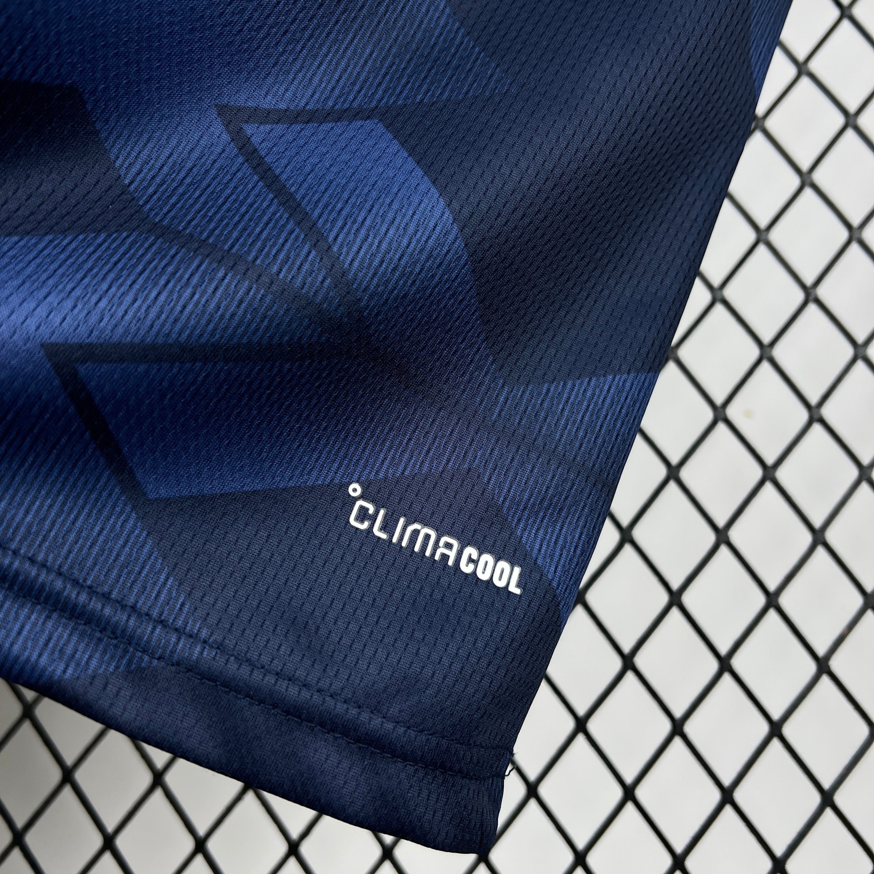 Leazofoot ÉCOSSE 2026 home jersey with dark blue geometric pattern and CLIMACOOL technology.