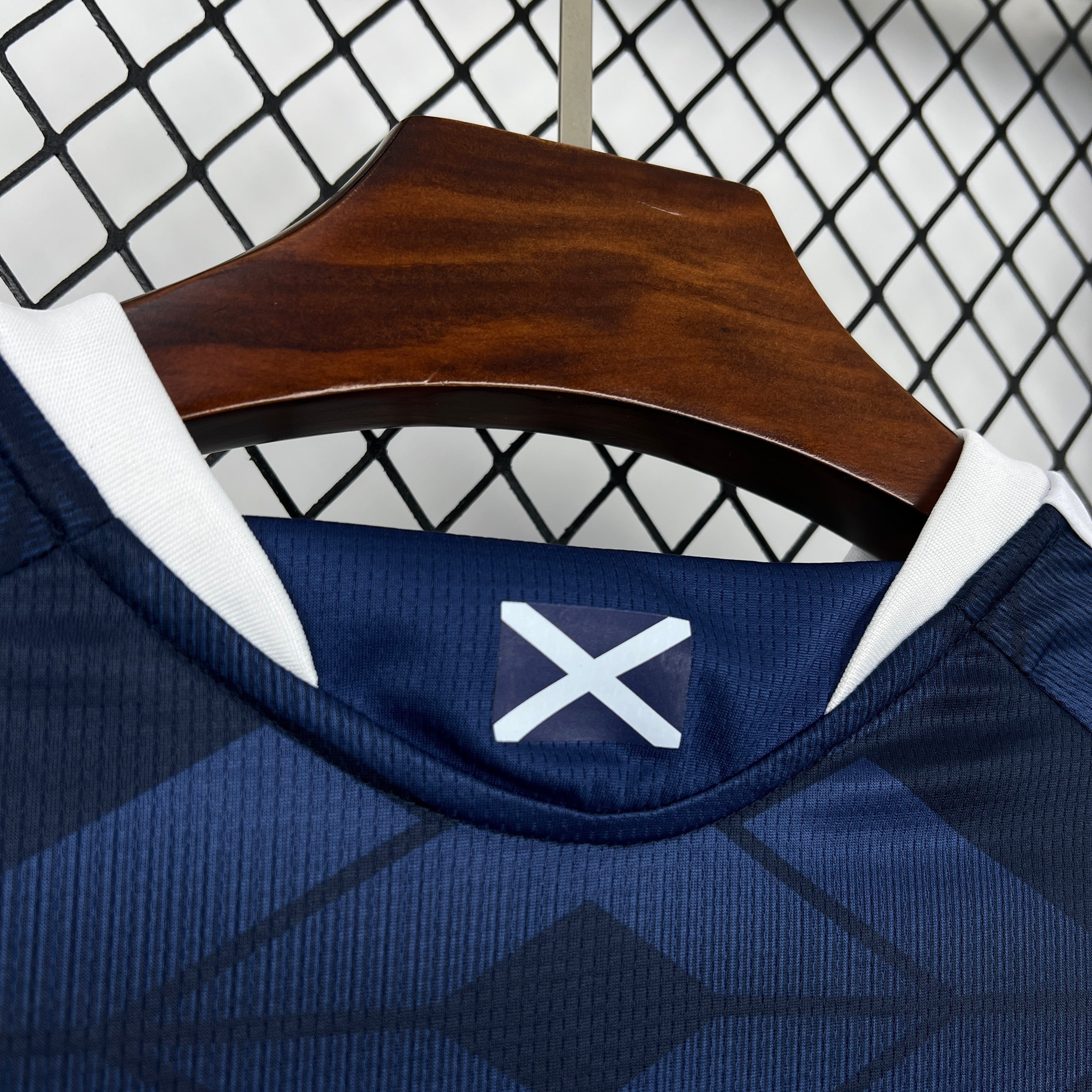 Leazofoot ÉCOSSE 2026 home jersey with navy tartan pattern and white trim.