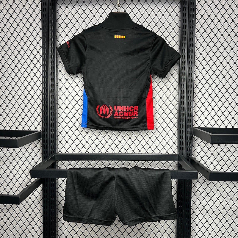 Leazofoot FC Barcelona 24/25 kids away kit featuring a black jersey with UNHCR logo and matching black shorts.