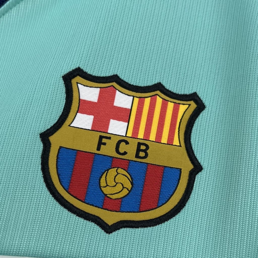Leazofoot FC Barcelona 26/27 third jersey featuring a detailed embroidered club crest on a light mint green fabric.