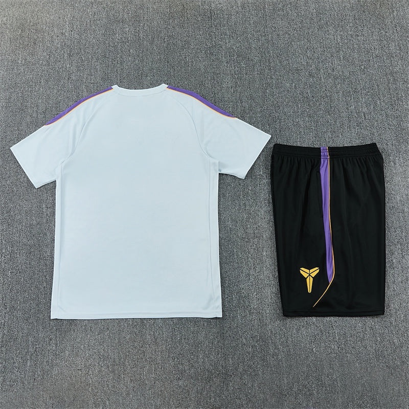 Leazofoot FC Barcelone 26/27 training set featuring a white t-shirt and black shorts with purple and gold accents
