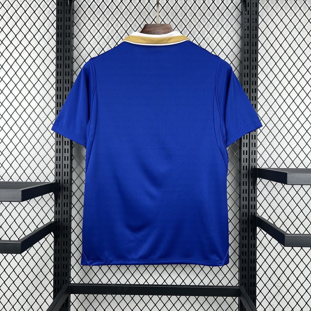 Leazofoot Finland 2026 away soccer jersey in blue with a white and gold polo collar, back view.