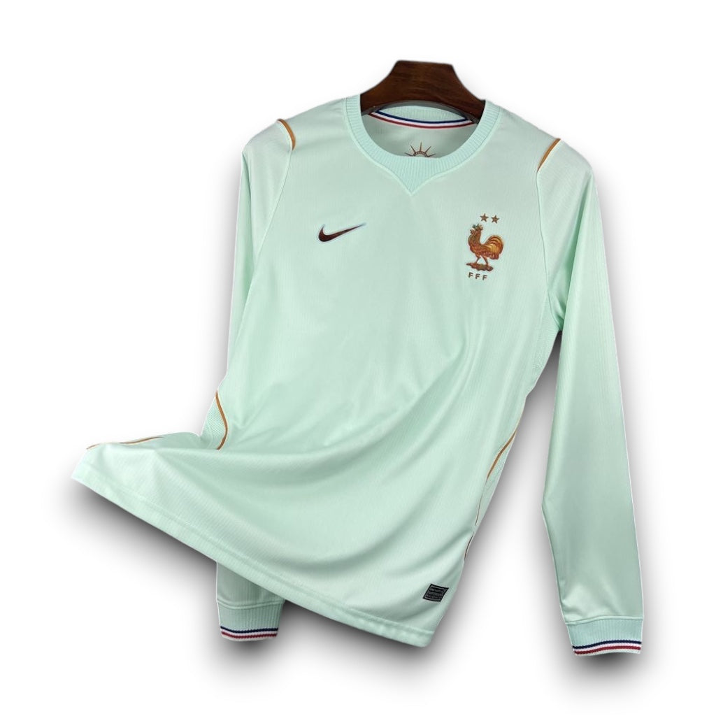 Leazofoot France 2026 long-sleeve away jersey in mint green with gold accents and FFF crest on a hanger.