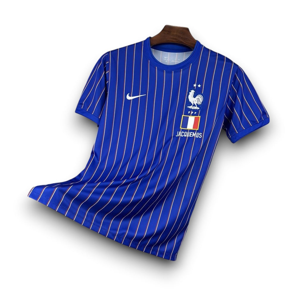Leazofoot France 2026 pre-match jersey in blue with vertical red and white pinstripes and team crest.