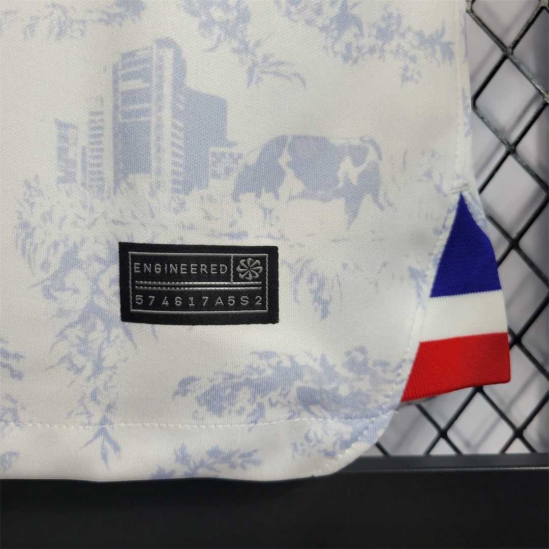 Leazofoot France 2022 away jersey featuring a white fabric with a blue toile de Jouy print and tricolor hem detail.