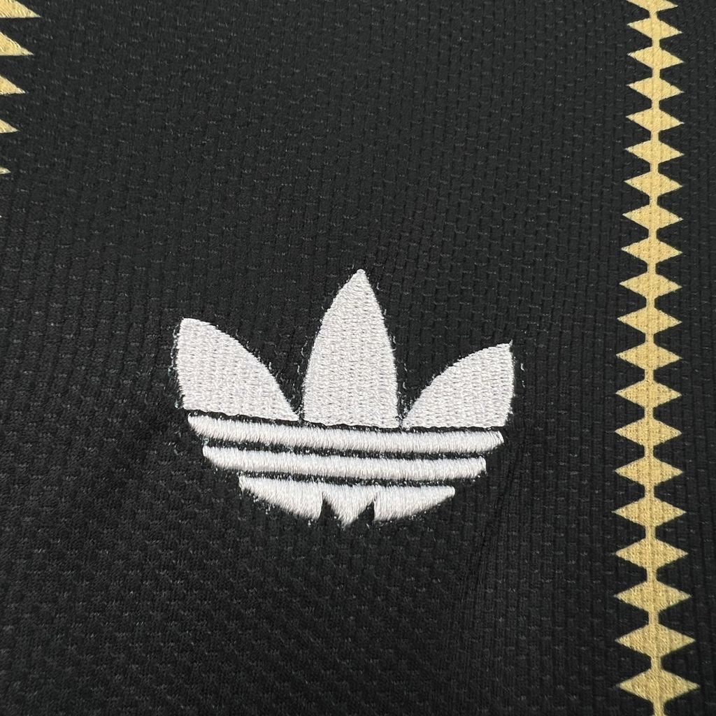 Leazofoot Germany 2026 third soccer jersey in black with white embroidered trefoil logo and gold geometric pattern.