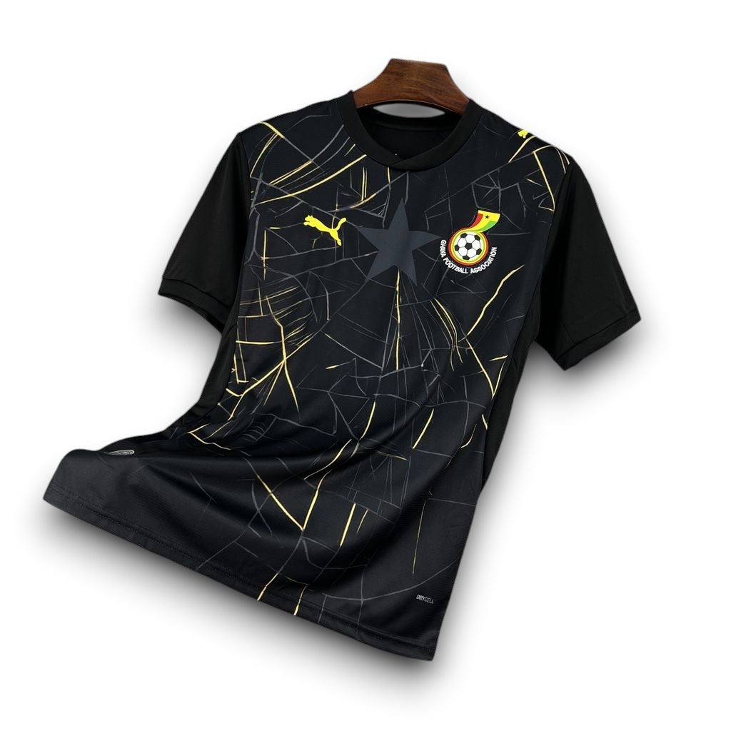 Leazofoot Ghana 2026 third football jersey in black with gold graphic patterns, Puma logo, and team crest.