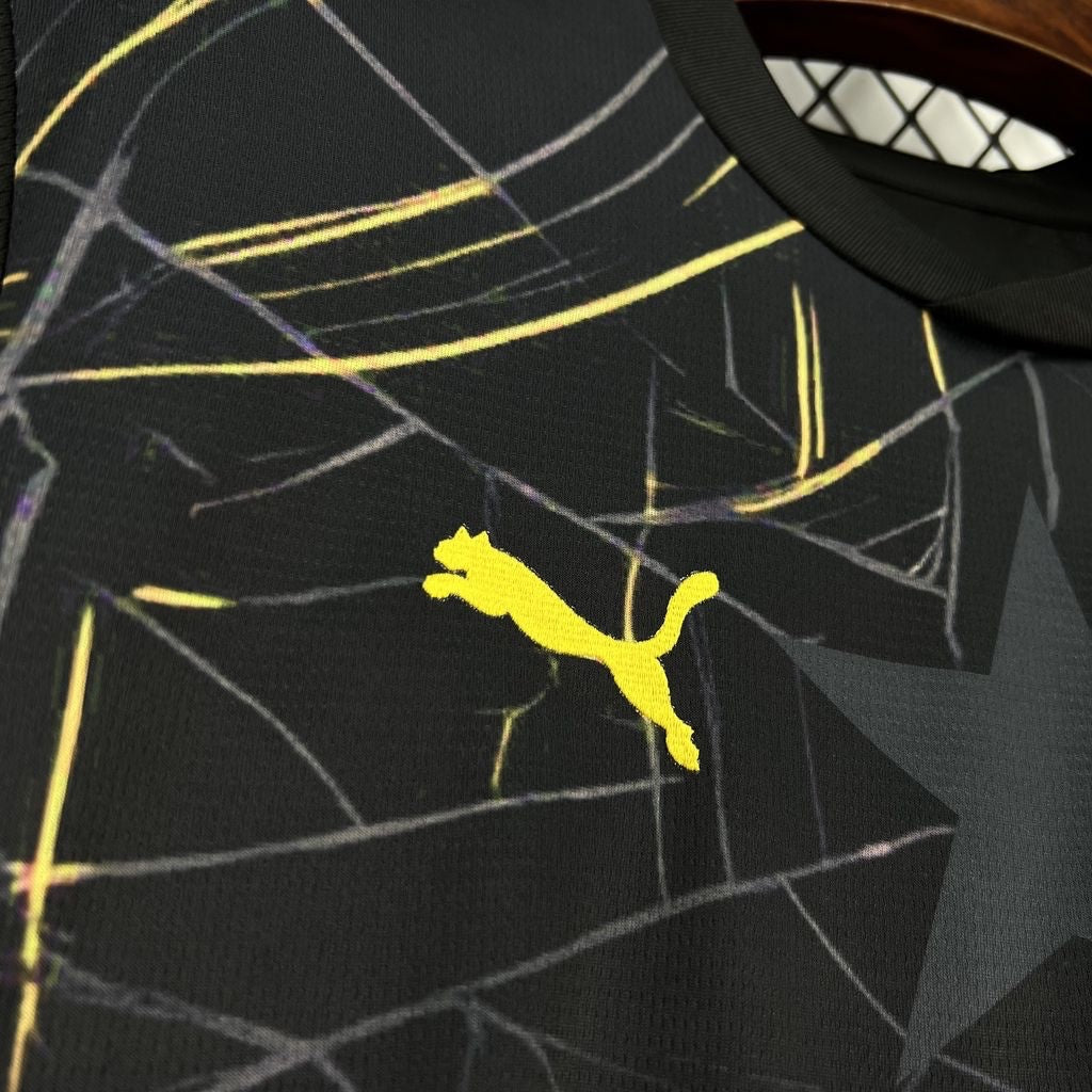 Leazofoot Ghana 2026 third jersey in black with yellow Puma logo and abstract geometric graphic pattern.