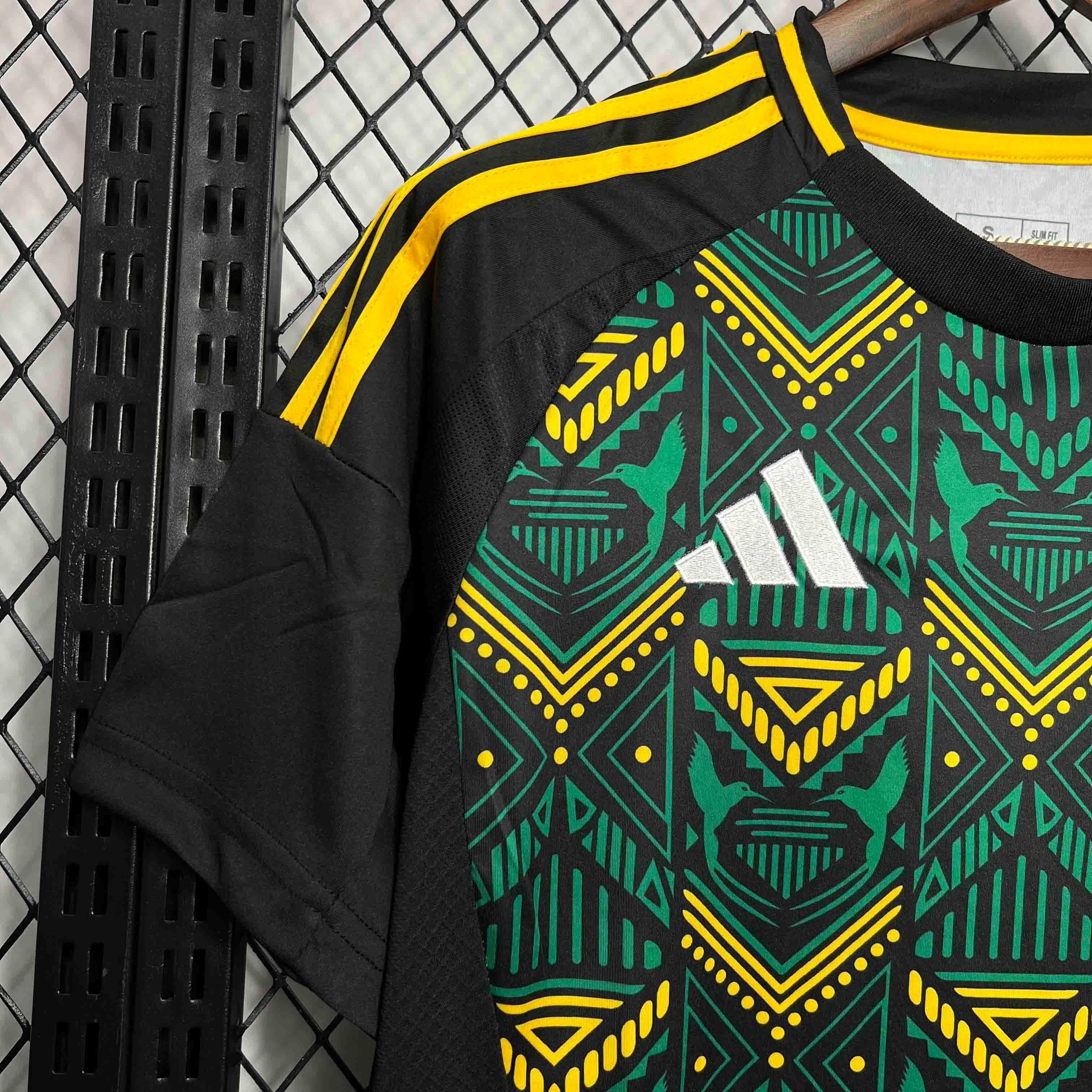 Leazofoot Jamaica 2024 away football jersey in black with green and yellow geometric patterns and white logo.