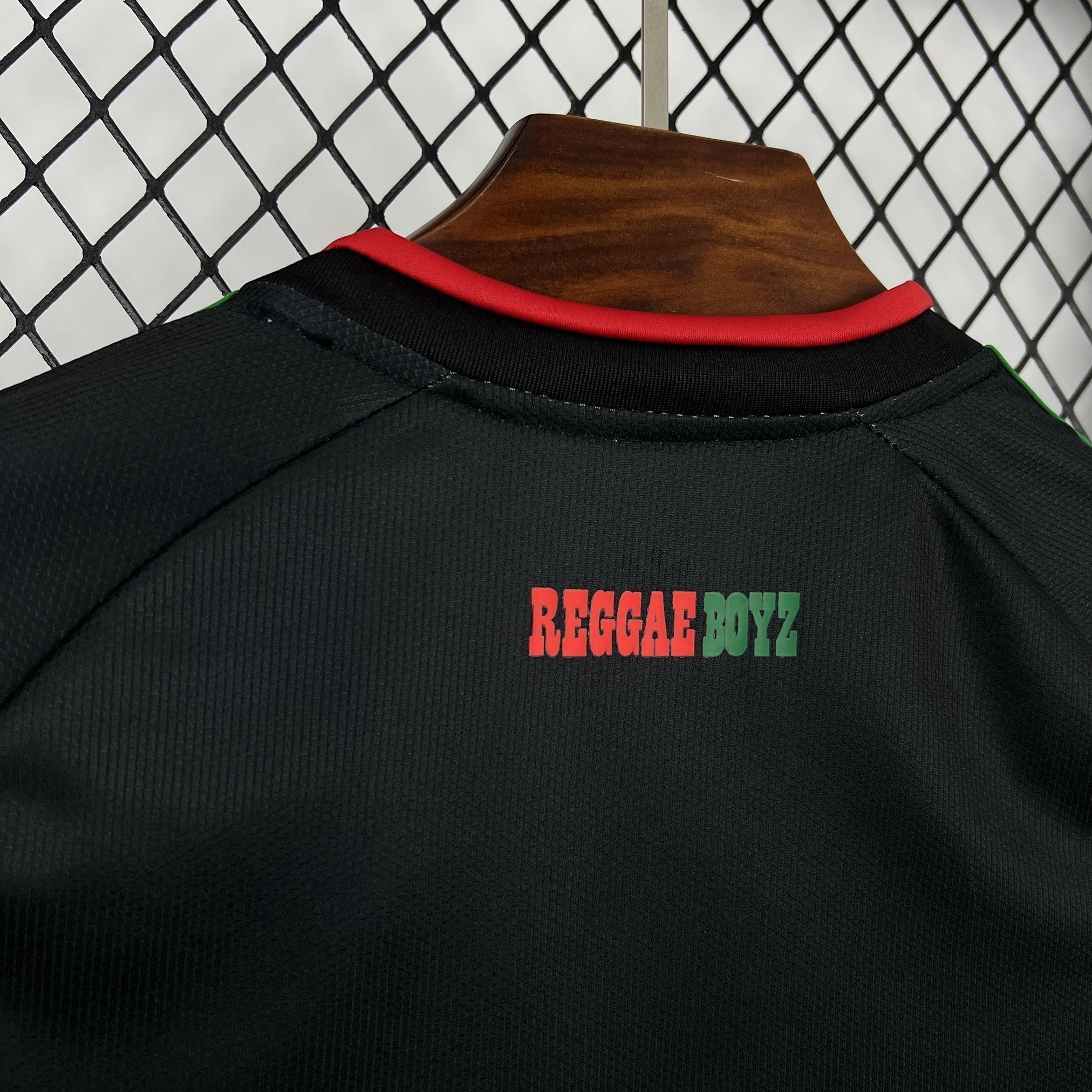 Leazofoot Jamaica 2026 away soccer jersey in black with red collar and Reggae Boyz text detail.