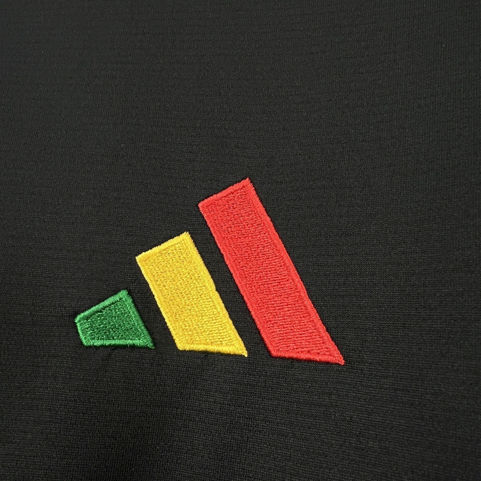 Leazofoot Jamaica 2026 concept soccer jersey featuring an embroidered green, yellow, and red logo on black fabric.