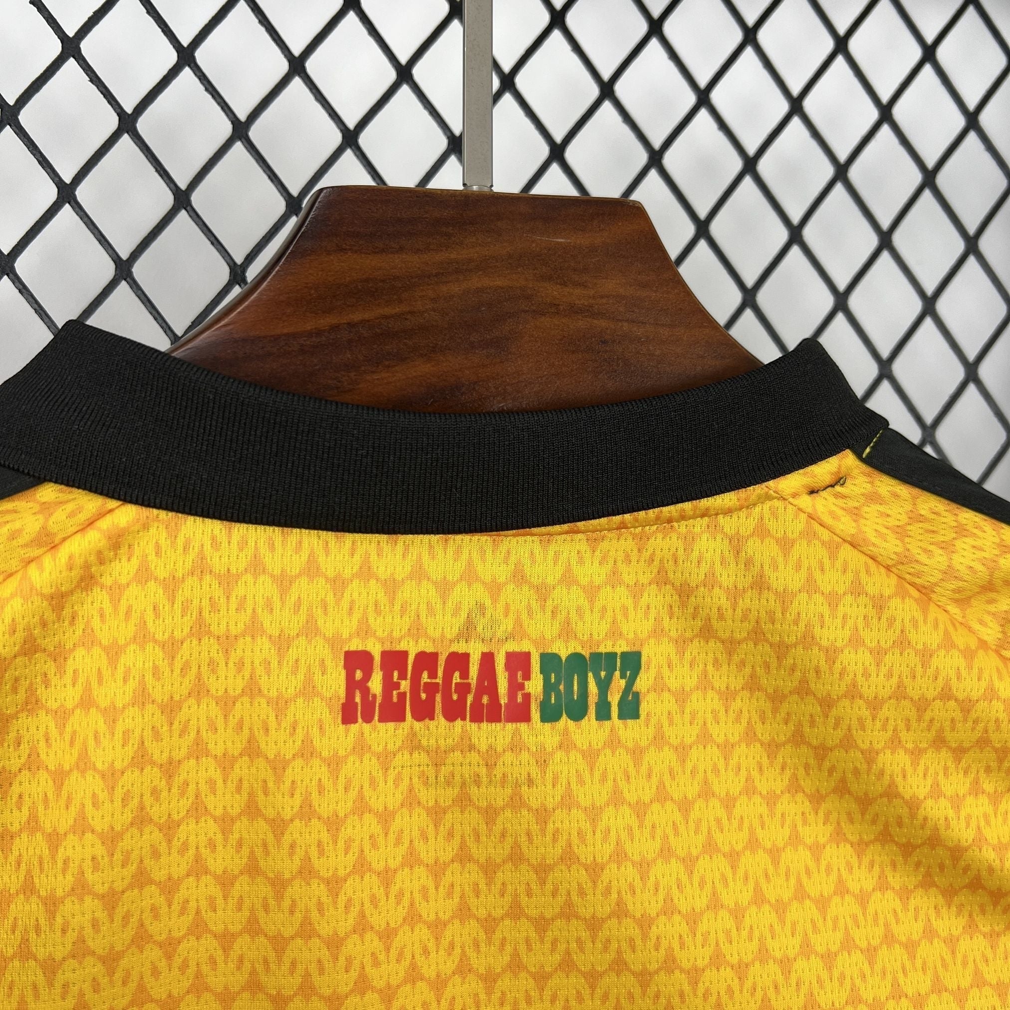 Leazofoot Jamaica 2026 home football jersey featuring a yellow textured fabric and Reggae Boyz back neck print.