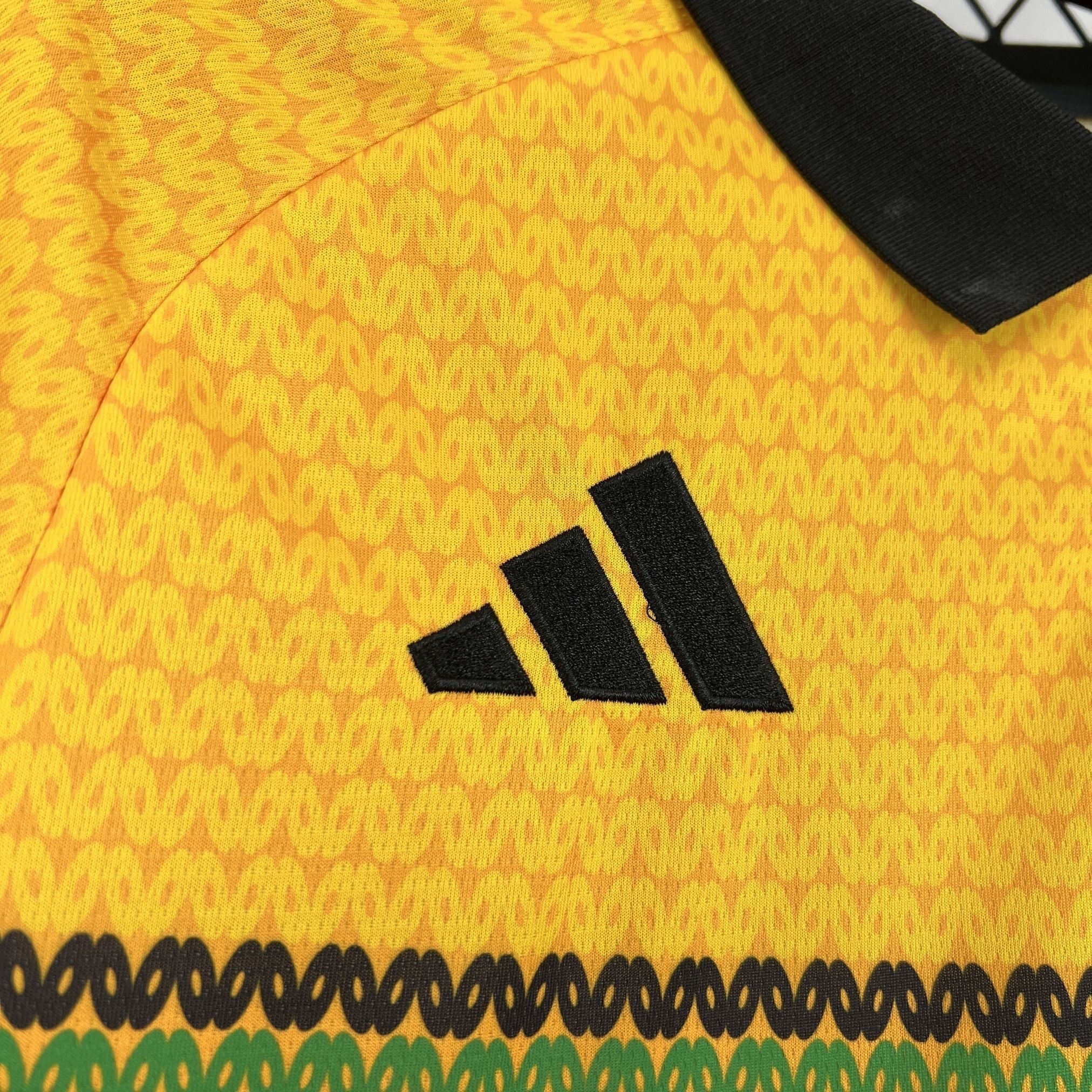 Leazofoot Jamaica 2026 home soccer jersey in yellow with black embroidered logo and patterned fabric detail.