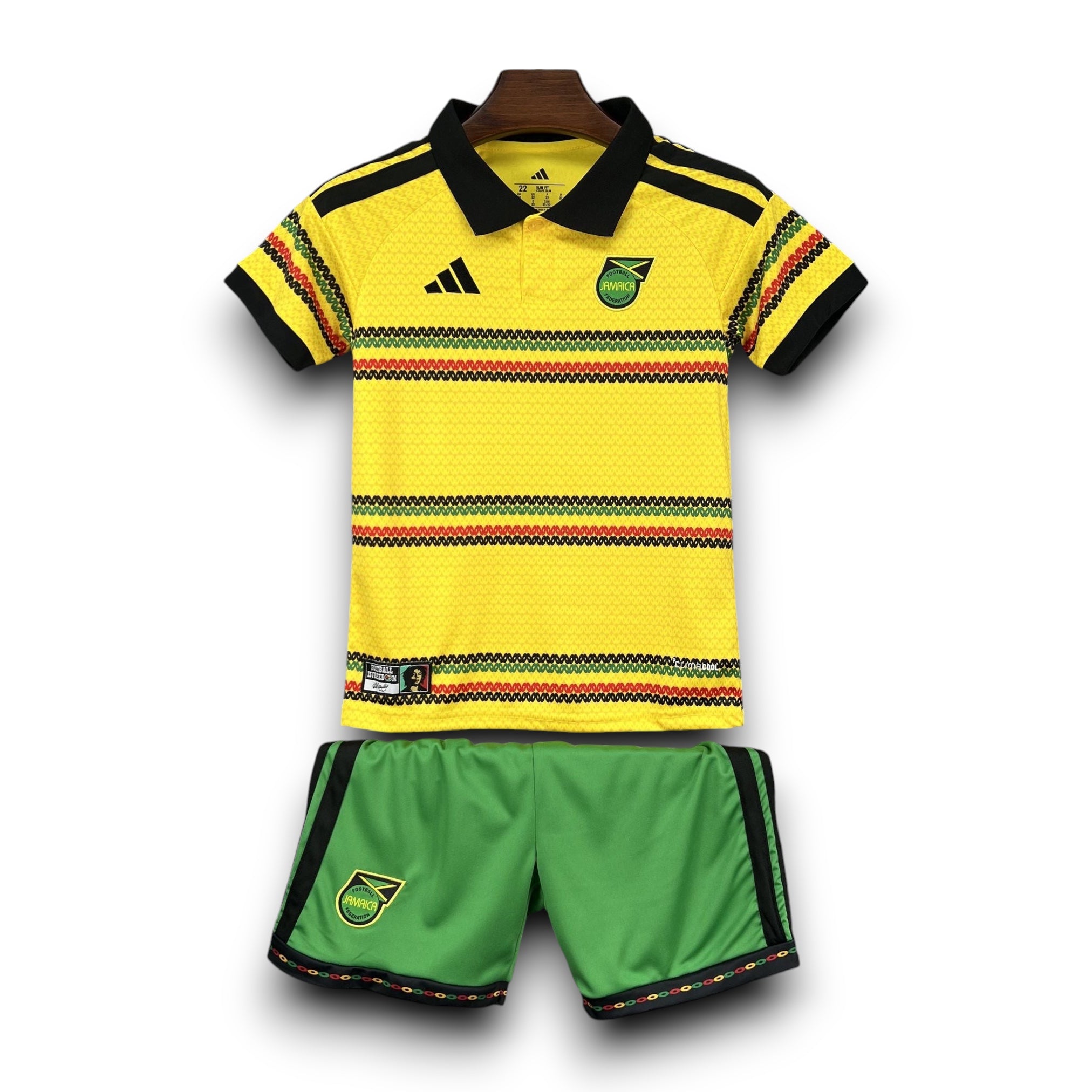 Leazofoot Jamaica 2026 kids home football kit with yellow polo shirt and green shorts featuring rasta-colored trim.