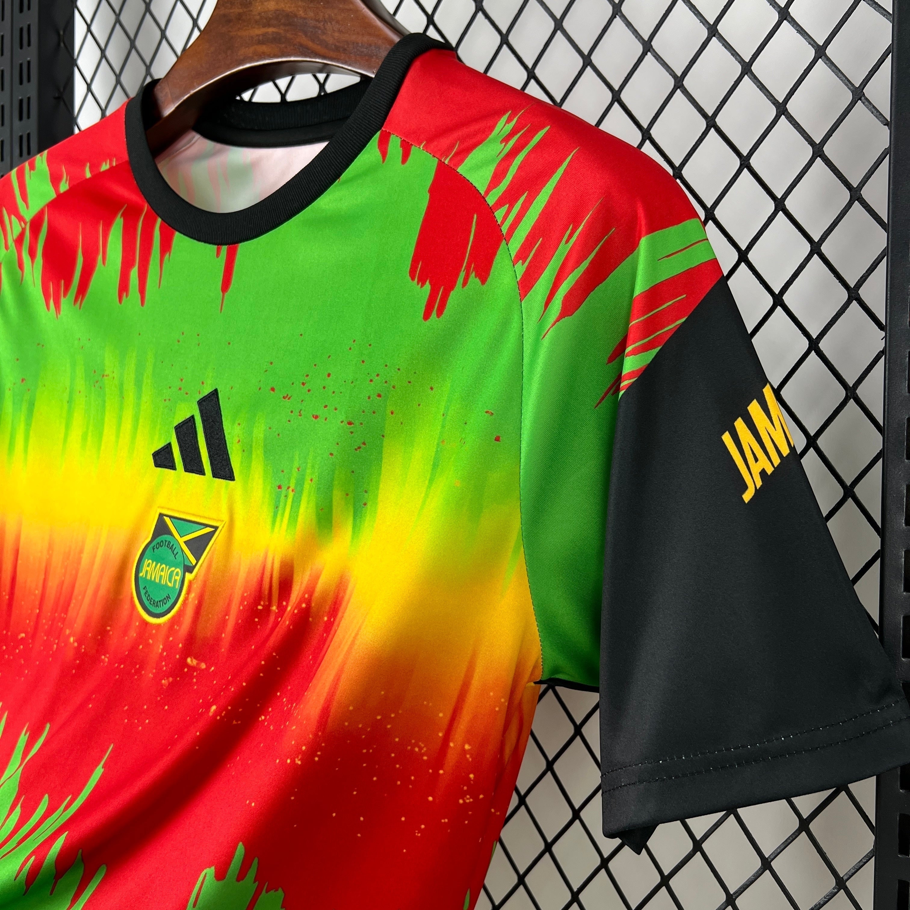 Leazofoot Jamaica 2026 pre-match football jersey featuring a vibrant red, yellow, and green brushstroke pattern.