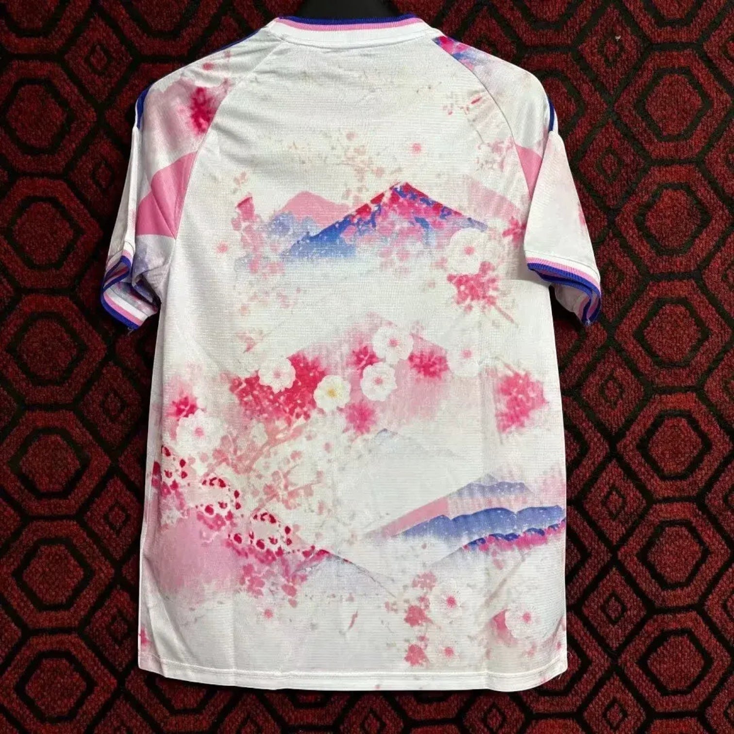 Leazofoot Japan 2024 concept soccer jersey featuring a white base with pink cherry blossom and mountain graphic print