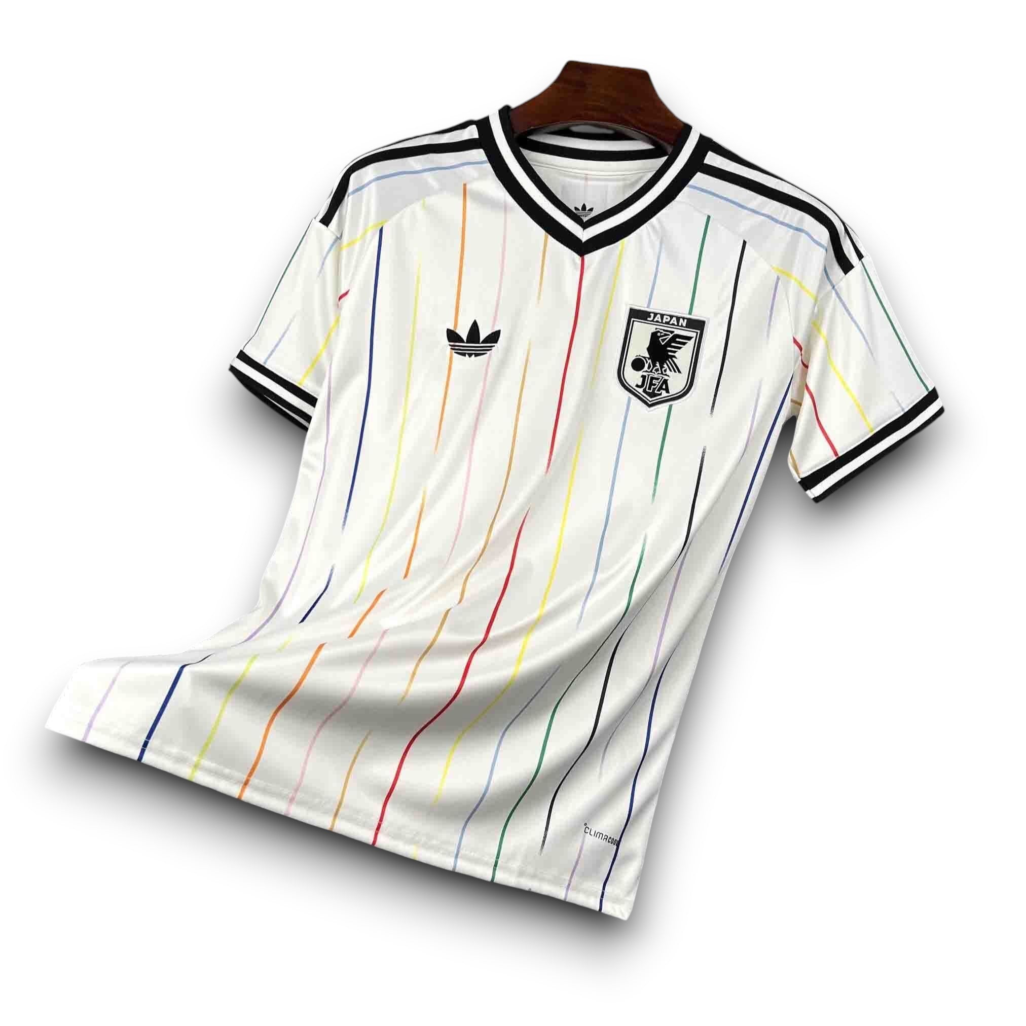 Leazofoot Japan 2026 away jersey with white base and multi-colored vertical stripes, black trim, and Adidas logo.
