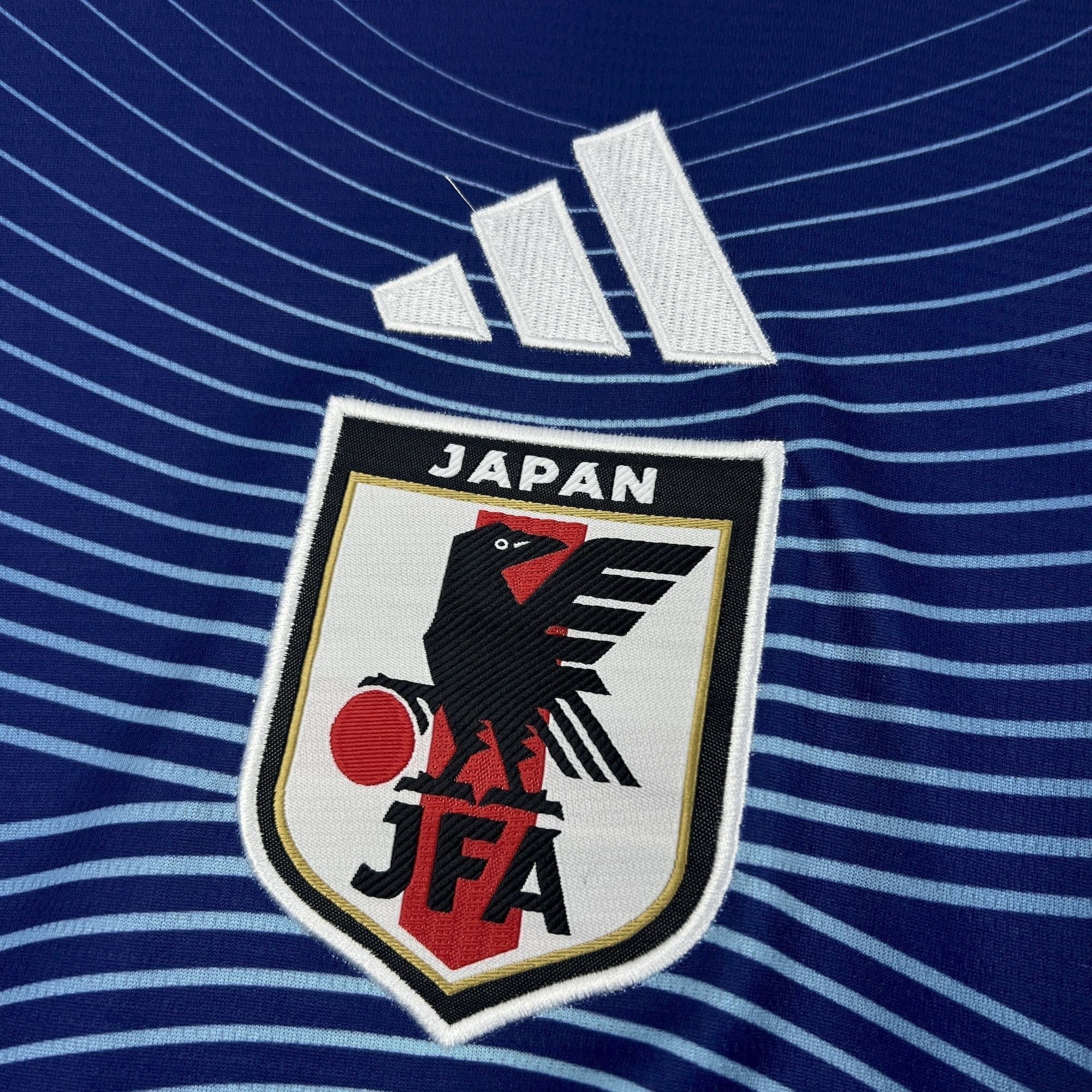 Leazofoot Japan home soccer jersey 2026 with blue wave pattern and embroidered crest.