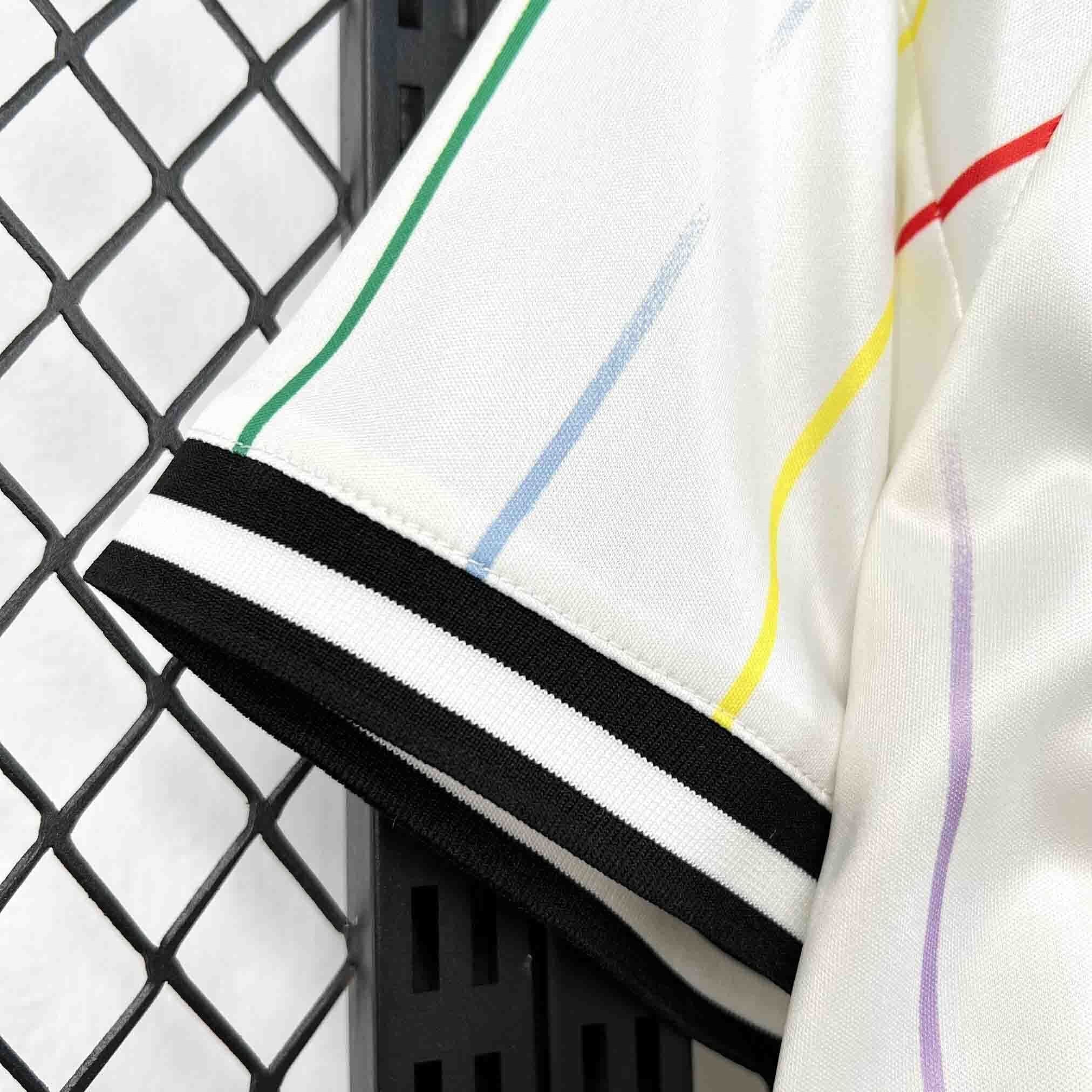 Leazofoot JAPON 2026 away jersey with thin multi-colored stripes and black and white striped cuffs.
