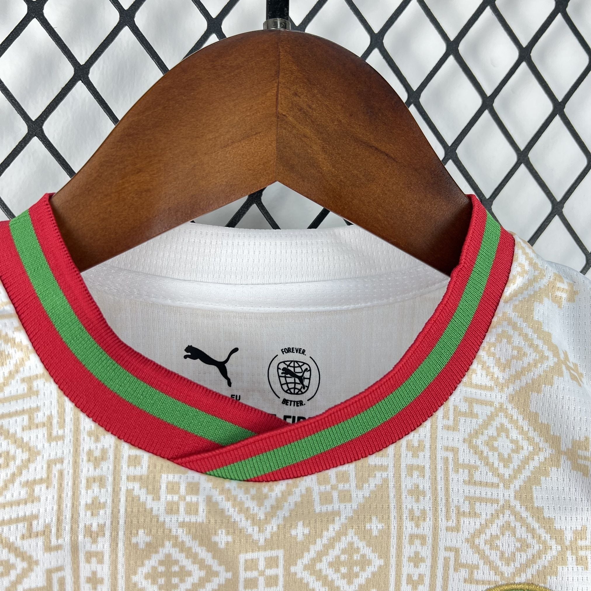 Leazofoot white and gold patterned kids' soccer jersey with red and green collar trim.