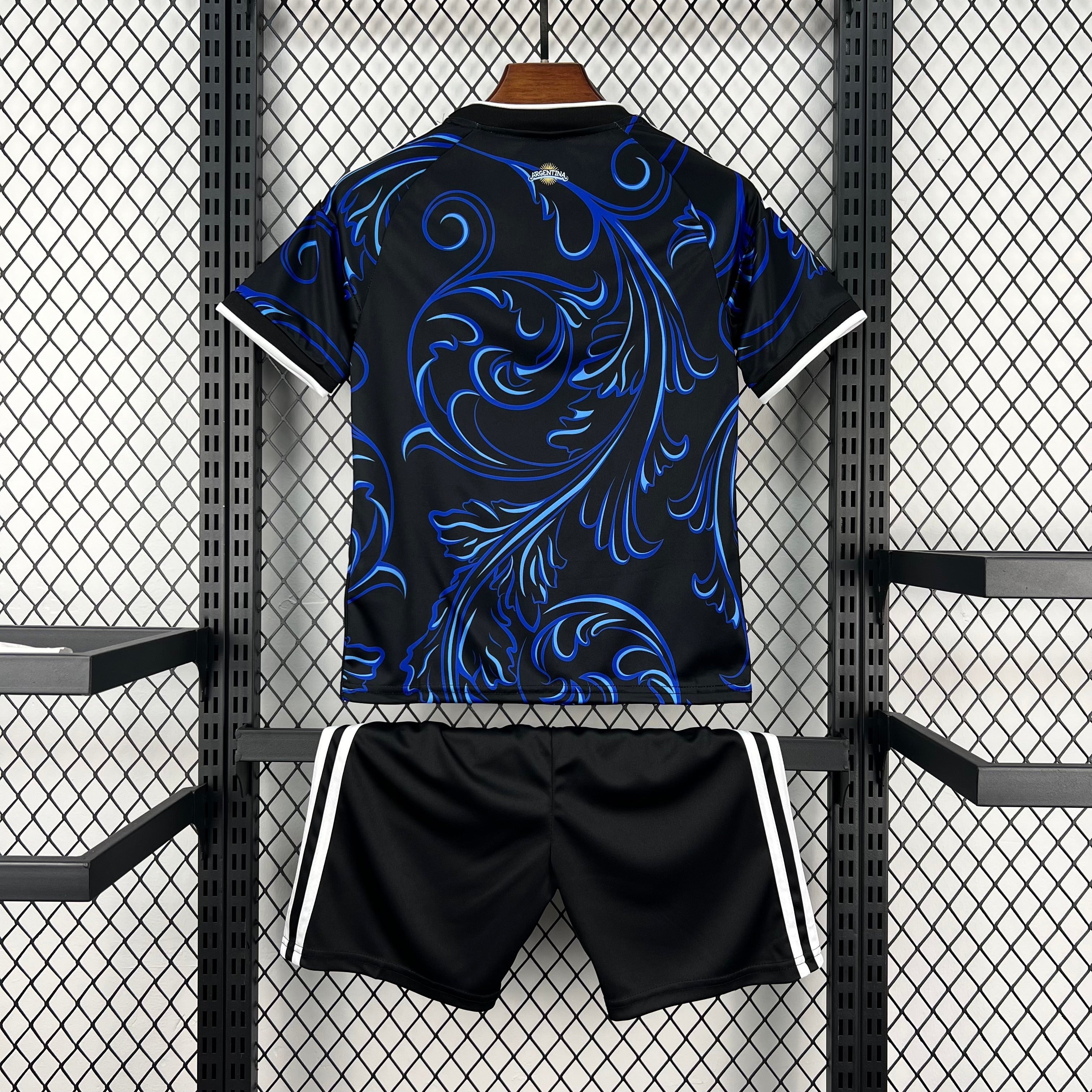 Leazofoot black kids' soccer uniform with blue ornate pattern on shirt and white stripes on shorts.