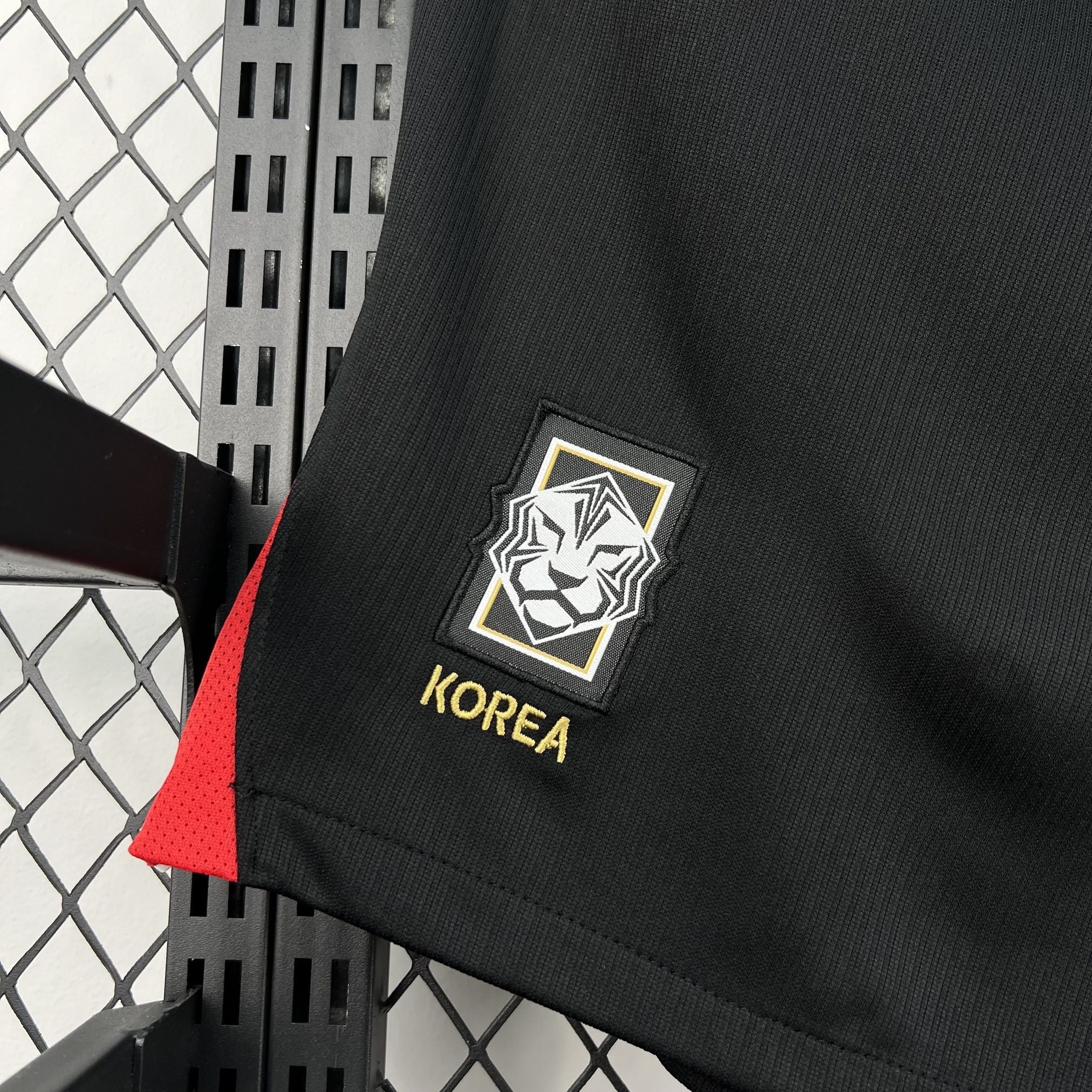 Leazofoot black football shorts with red side panels and embroidered Korea crest and text.