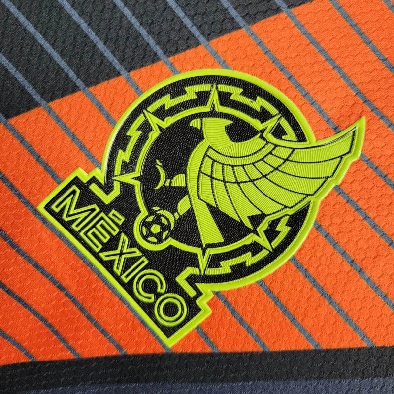 Leazofoot 2010 Mexico away soccer jersey featuring a vibrant lime green and black Aztec-inspired team crest detail.