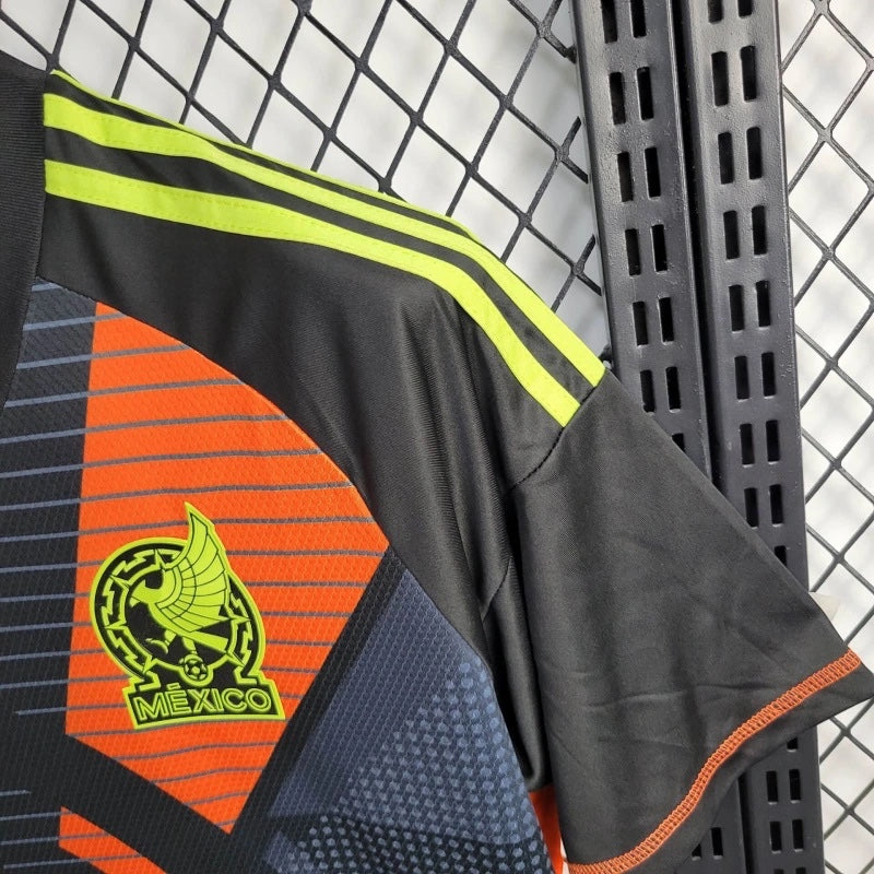 Leazofoot 2010 Mexico away soccer jersey in black with orange geometric patterns and neon yellow accents.