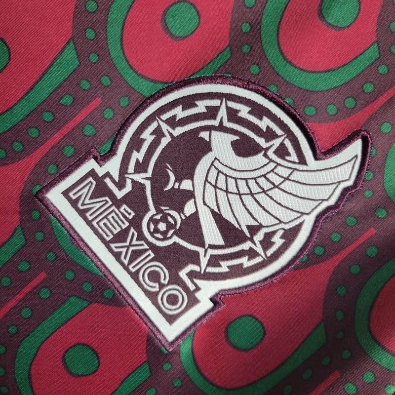 Leazofoot Mexico 2024 home soccer jersey featuring a detailed embroidered team crest on a red and green patterned fabric