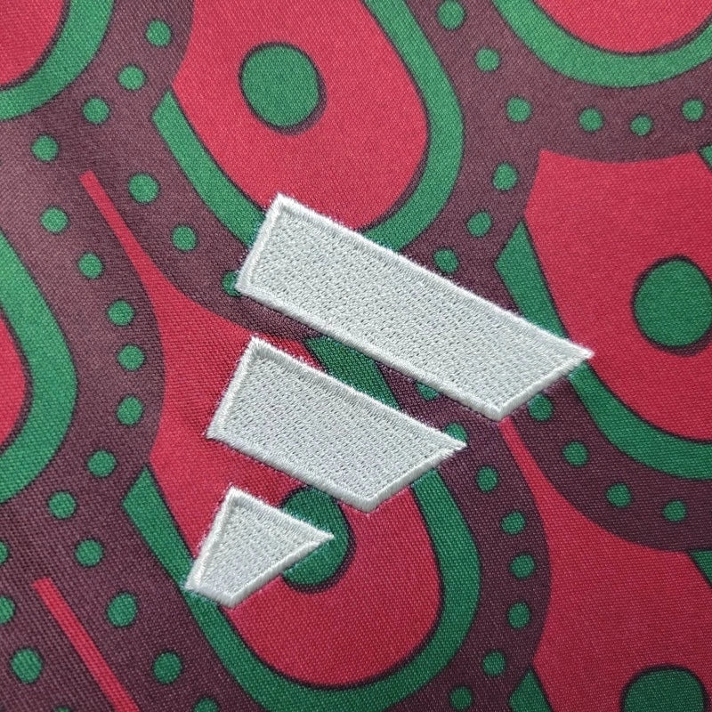 Leazofoot Mexico 2024 home jersey featuring a red, green, and dark maroon patterned fabric with an embroidered logo.