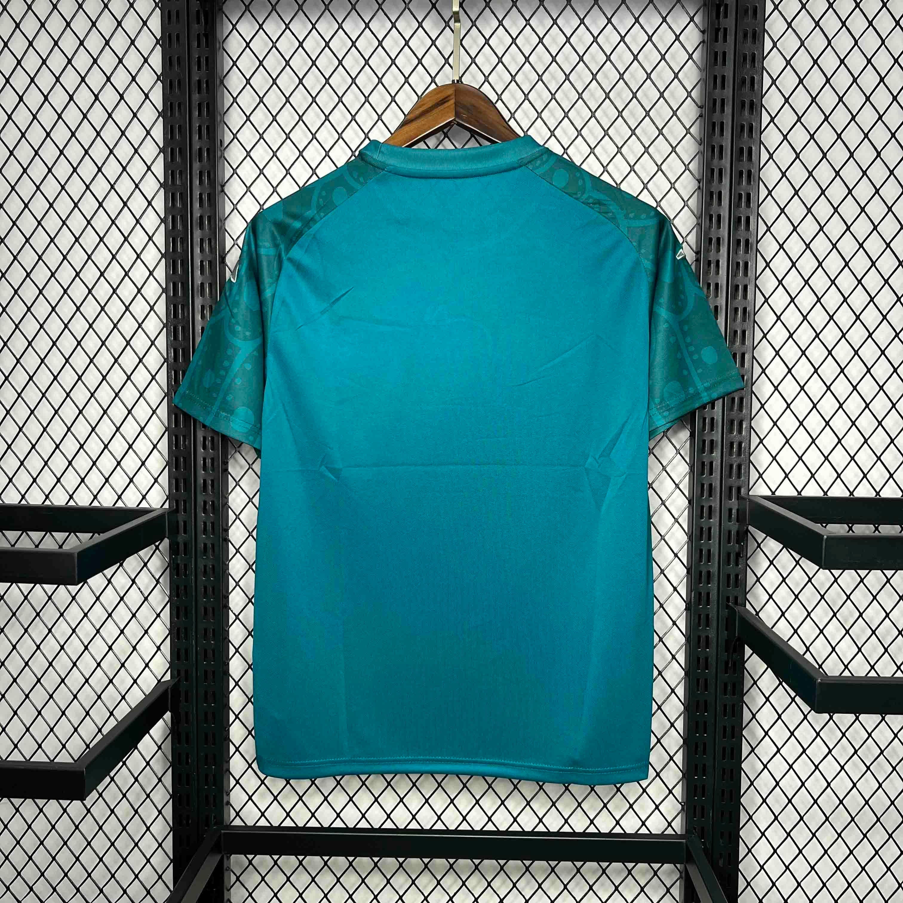 Leazofoot Mexico 24/25 special edition teal soccer jersey with patterned sleeves hanging on a wooden hanger.