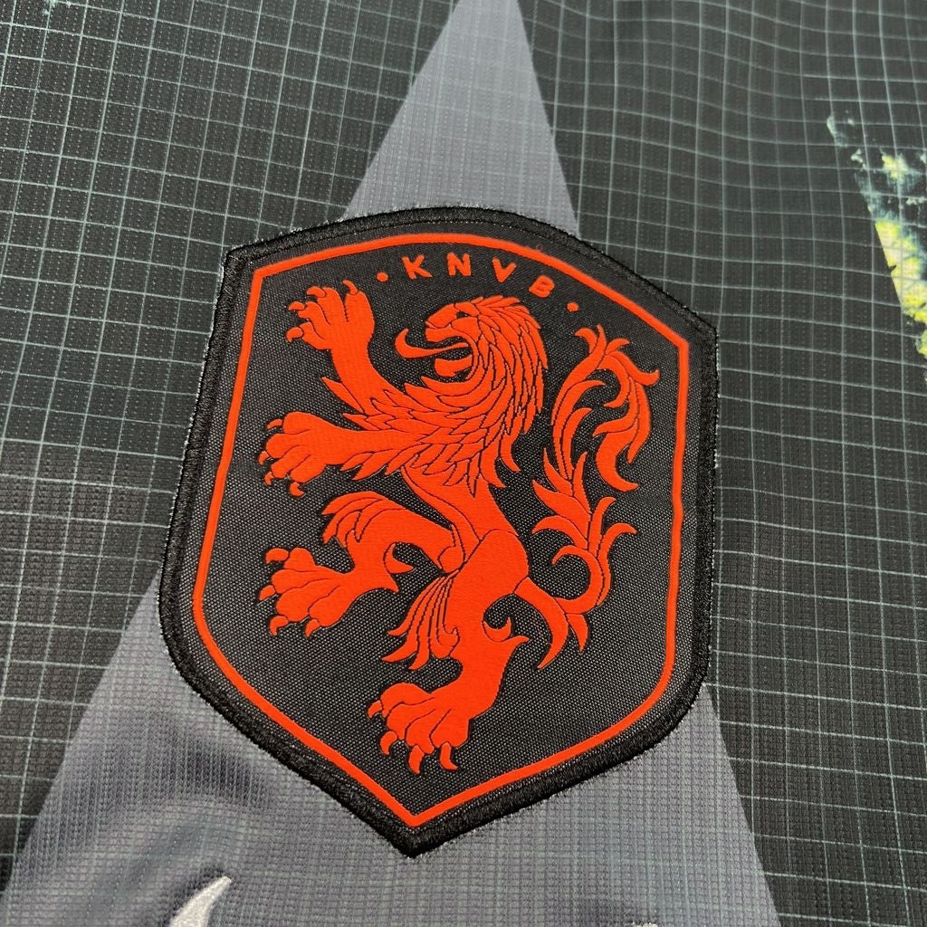 Leazofoot Netherlands 2026 goalkeeper jersey featuring a detailed orange KNVB lion crest on a black grid pattern fabric