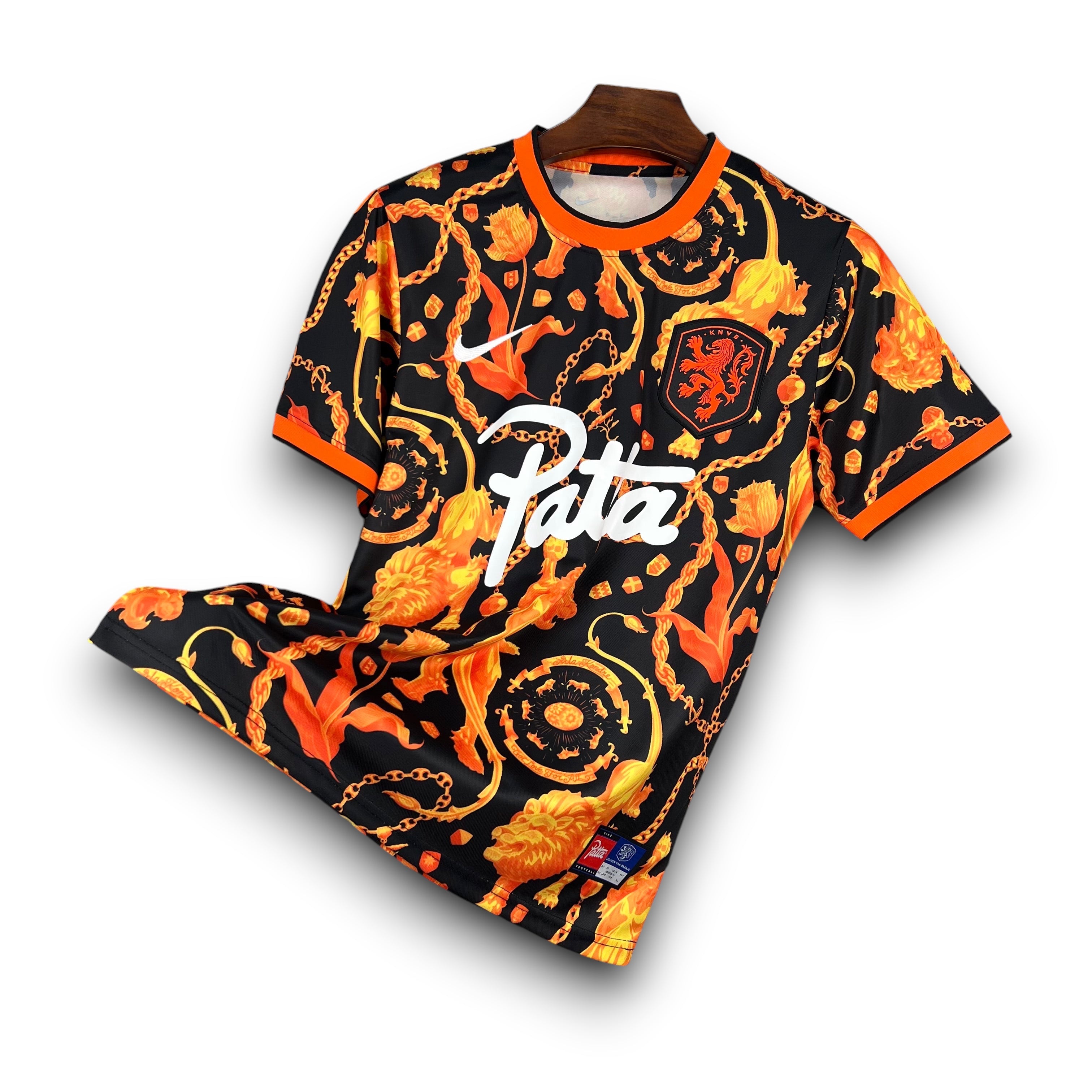 Leazofoot black football jersey with orange and gold baroque pattern, featuring a lion crest and Patta logo.