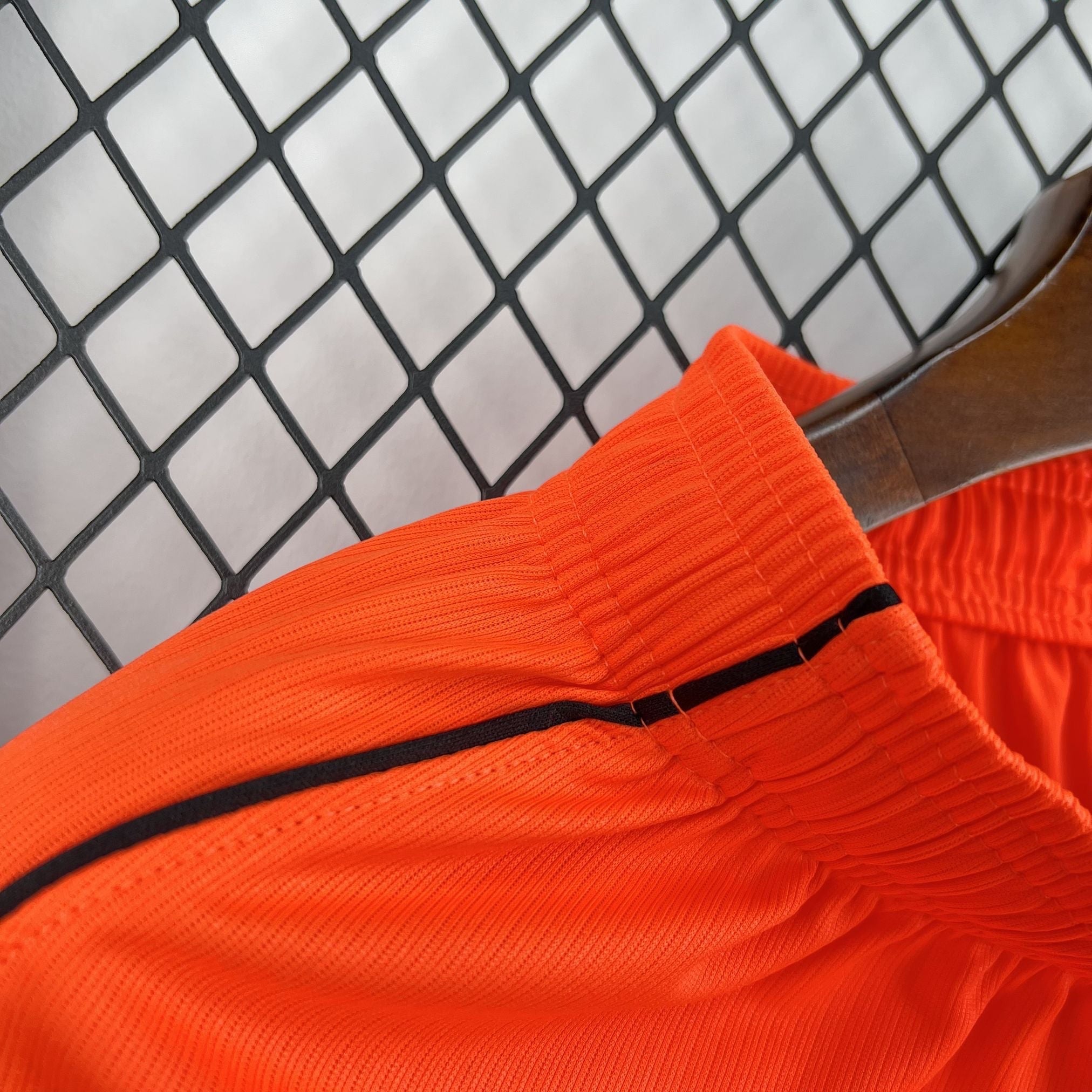 Leazofoot orange athletic shorts with black trim and elastic waistband