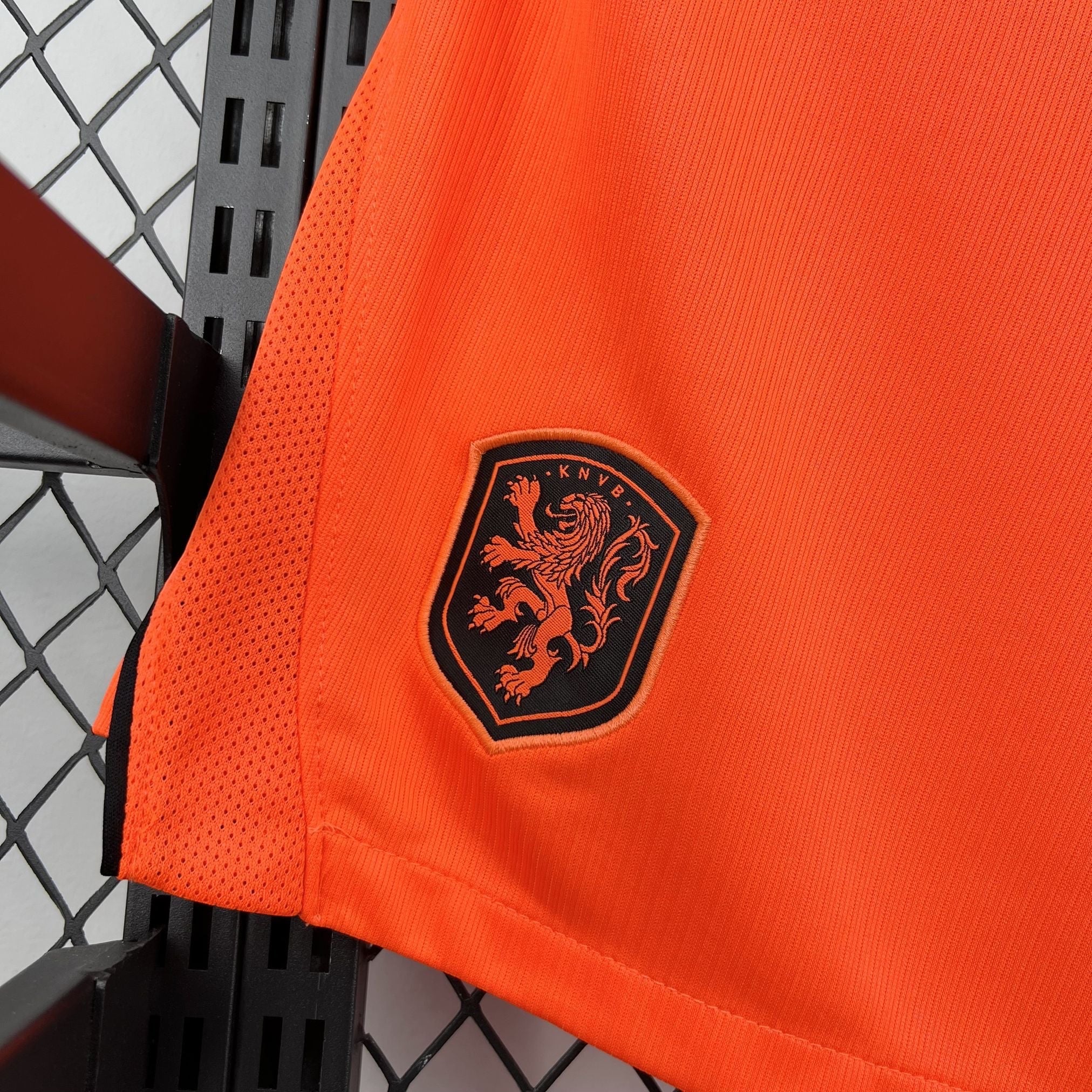 Leazofoot orange football shorts with KNVB lion crest detail. Mesh side panels for breathability.