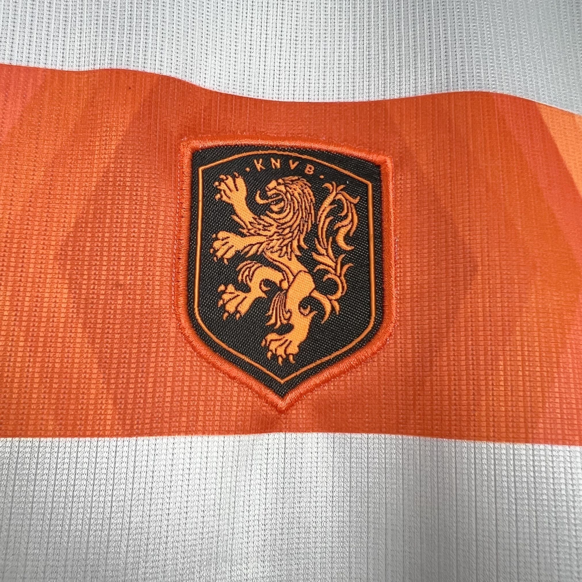 Leazofoot orange and white child's soccer jersey with embroidered KNVB lion crest.