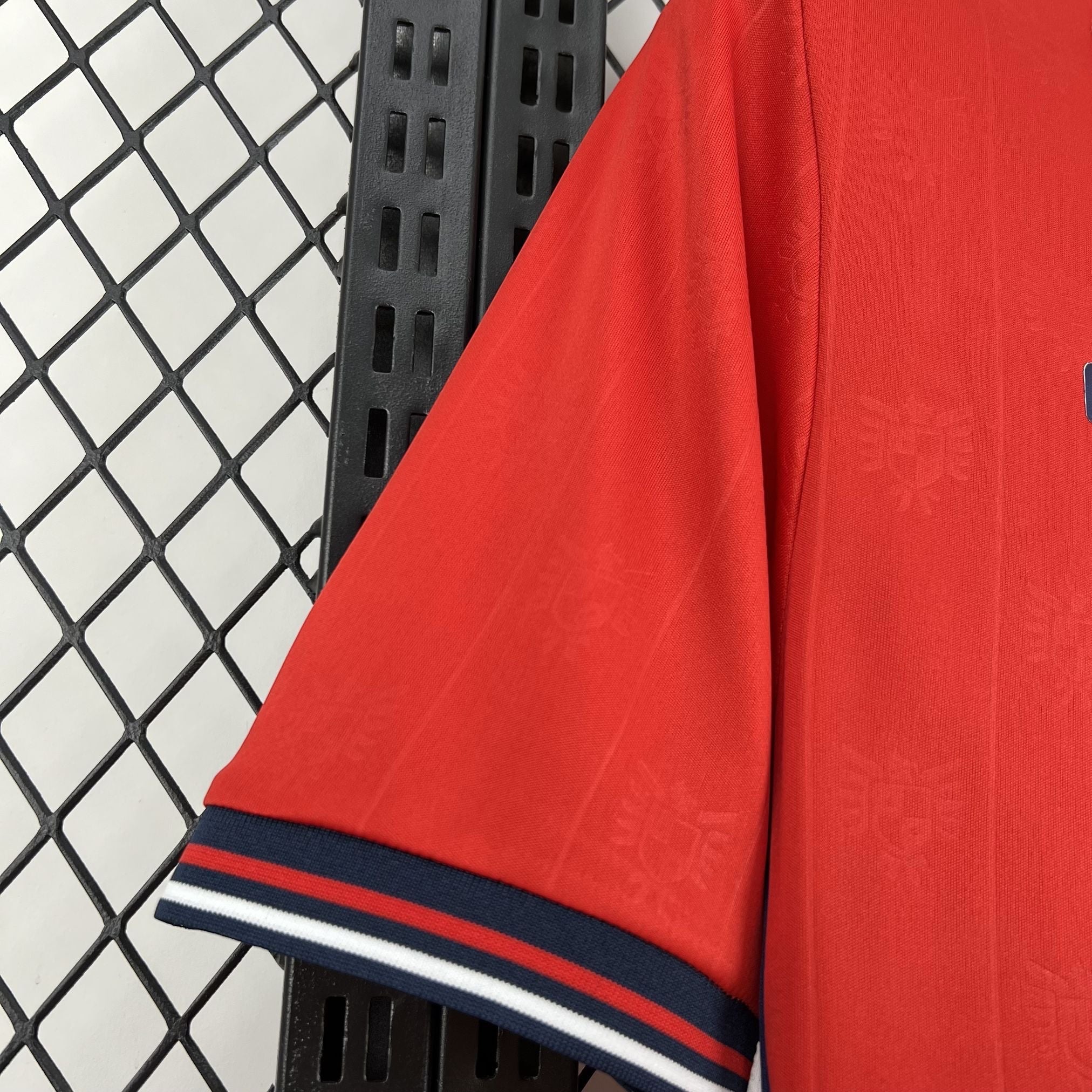 Leazofoot PANAMA home jersey 2026 in red with subtle embossed crest pattern and striped cuffs.