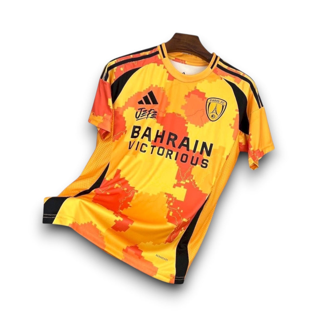 Leazofoot Paris FC 25/26 third football jersey in yellow and orange with pixelated pattern and black sponsor logos.