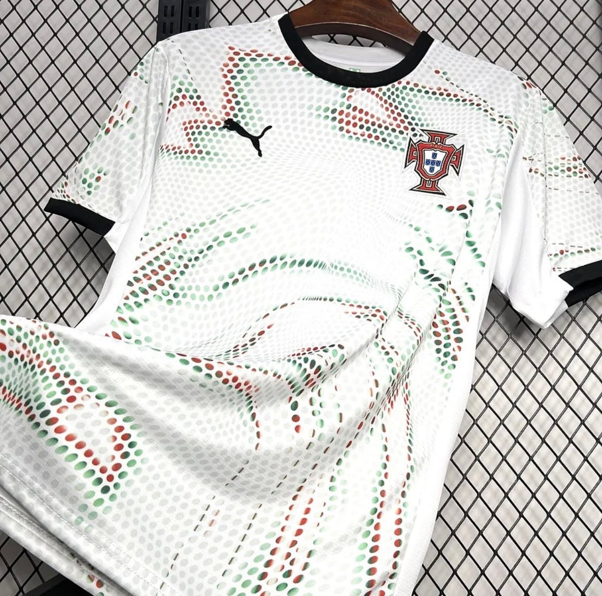 Leazofoot Portugal 2025 away football jersey in white with red and green dotted graphic pattern and black trim.