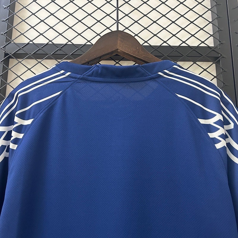 Leazofoot Paris Saint Germain 24/25 fourth jersey in blue with white shoulder stripe detailing on a wooden hanger.