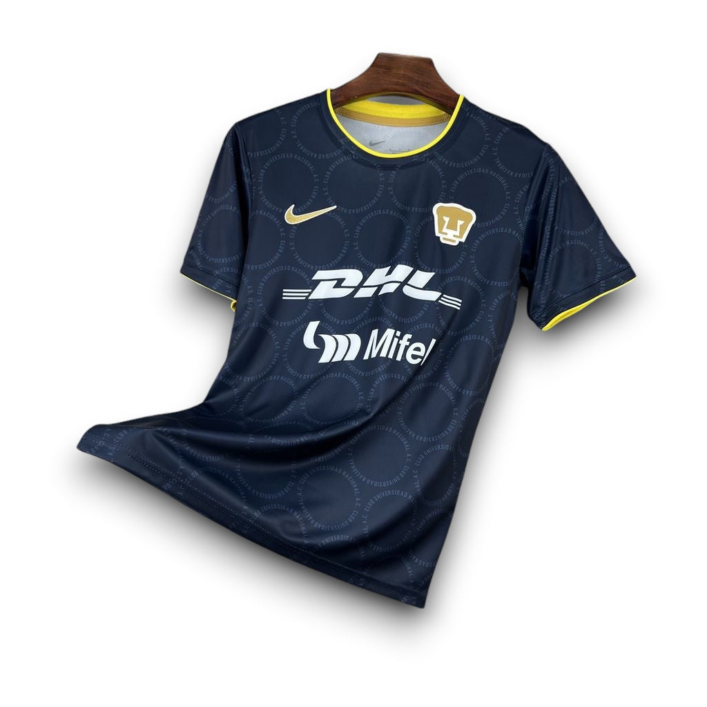 Leazofoot Pumas 26/27 away soccer jersey in navy blue with yellow trim, featuring team crest and sponsor logos.