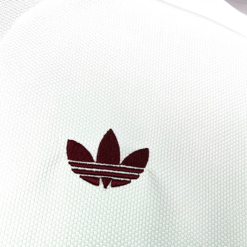 Leazofoot Qatar 2026 away jersey featuring a white textured fabric with an embroidered maroon Adidas trefoil logo.